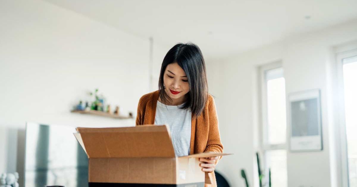 Woman carefully opening a package. Representative Cover Image Source: Getty Images | Oscar Wong