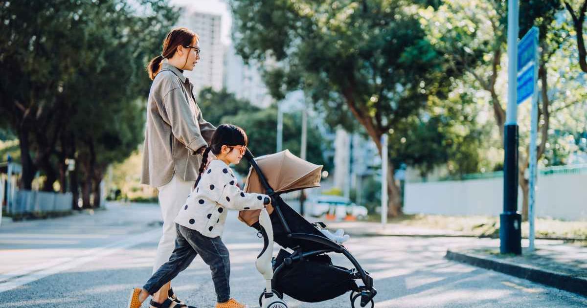 Mom with toddler daughter and baby in stroller. Representative Cover Image Source: Getty Images | d3sign