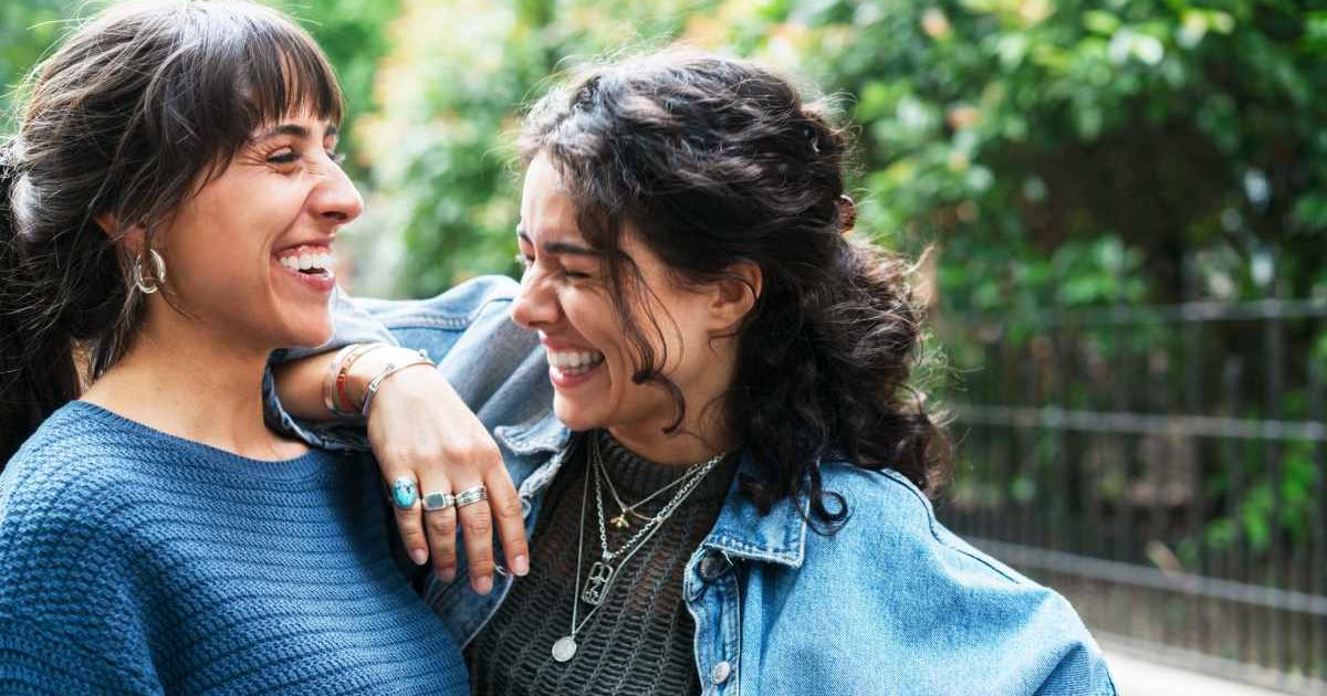 Two women talking and smiling at each other. Representative Cover Image Source: Getty Images | Tim Robberts