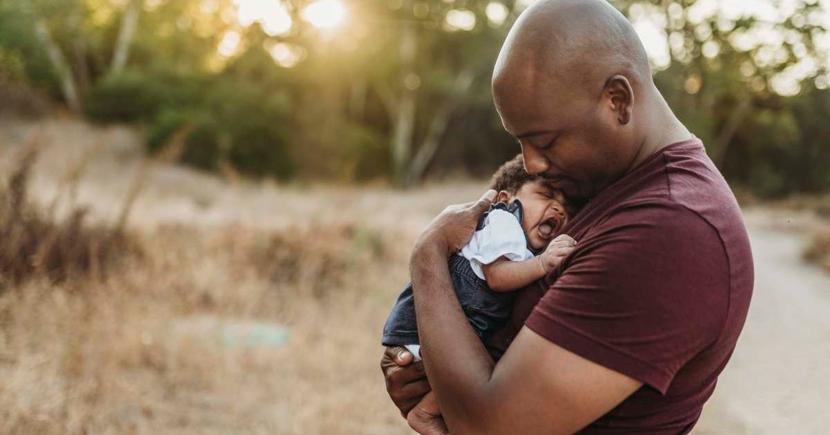A man holding a newborn. (Representative Cover Source: Getty Images | Photo by Cavan Images)