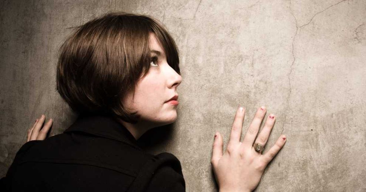 Woman holding the wall, scared. (Representative Cover Image Source: Getty Images | Photo by 	halbergman)