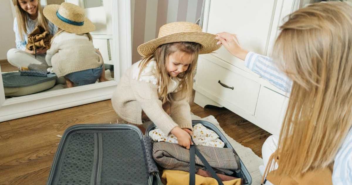 Mom and daughter packing their luggage before a trip. Representative Cover Image Source: Pexels | Ivan S