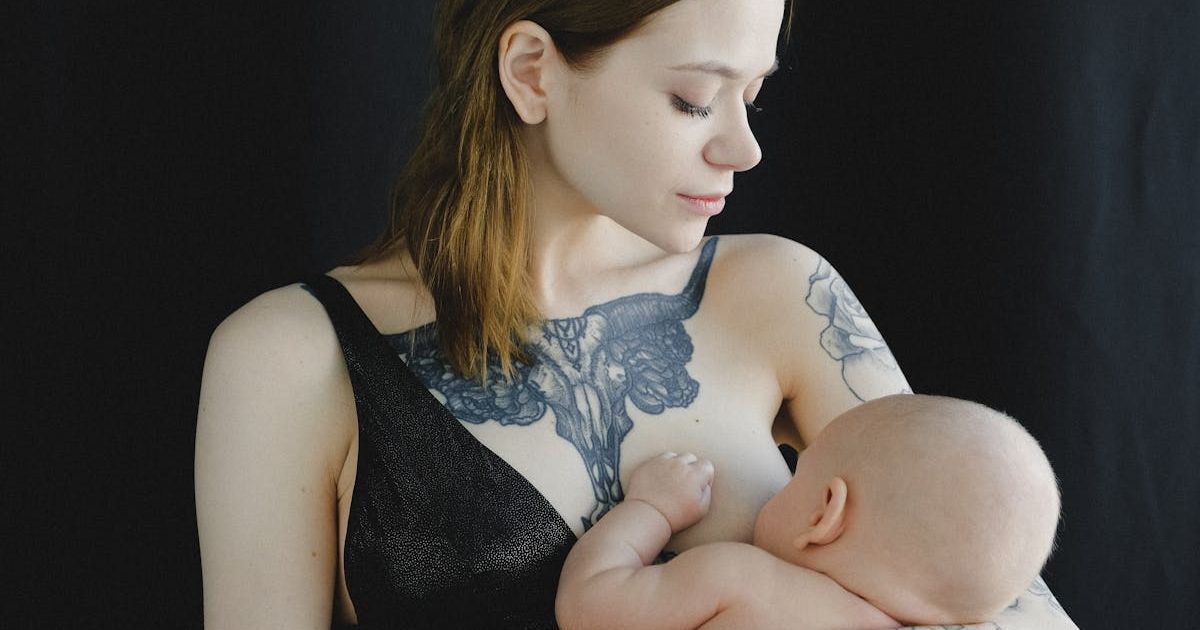 Mom breastfeeding baby in an outdoor space. Representative Cover Image Source: Pexels | Anna Shvets