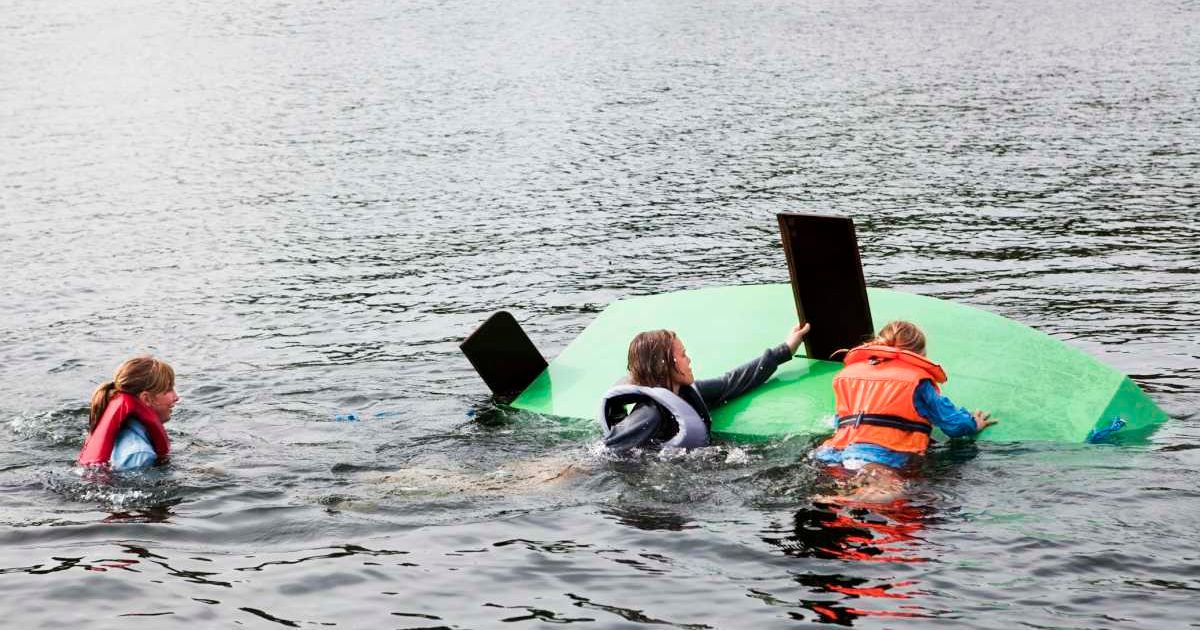 Family swimming around a capsized boat. Representative Cover Image Source: Getty Images | Johner Images