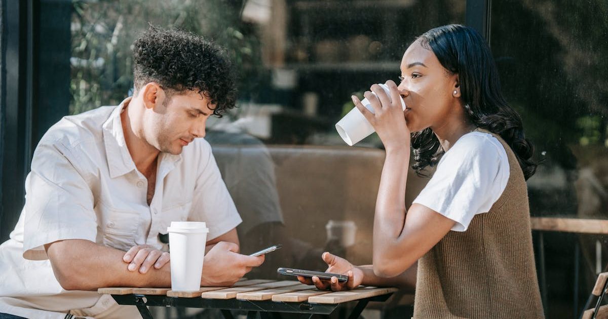 Two people drinking coffee outside a coffee shop. Representative Cover Image Source: Pexels | Mike Jones