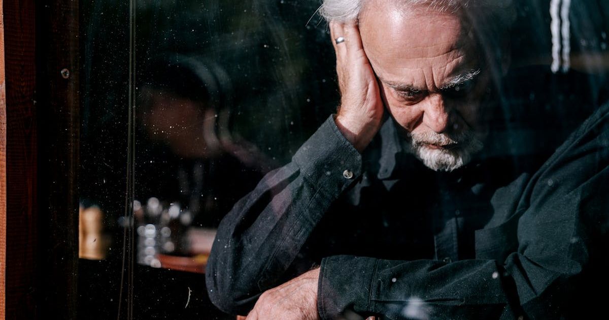 Unwell old man holding onto his head. Representative Cover Image Source: Pexels | Ivan S