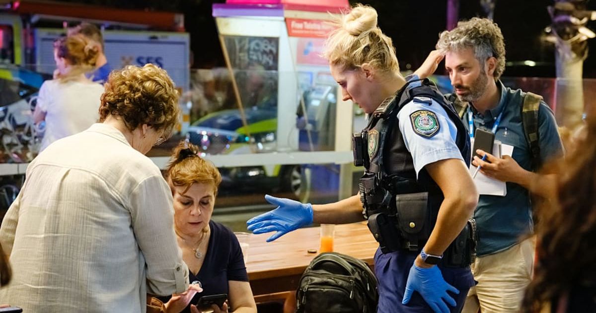 SYDNEY, AUSTRALIA - DECEMBER 14: Police first responders speak to members of the public at the scene of a mass shooting at Bondi Beach on December 14, 2025 in Sydney, Australia. (Photo by George Chan/Getty Images)