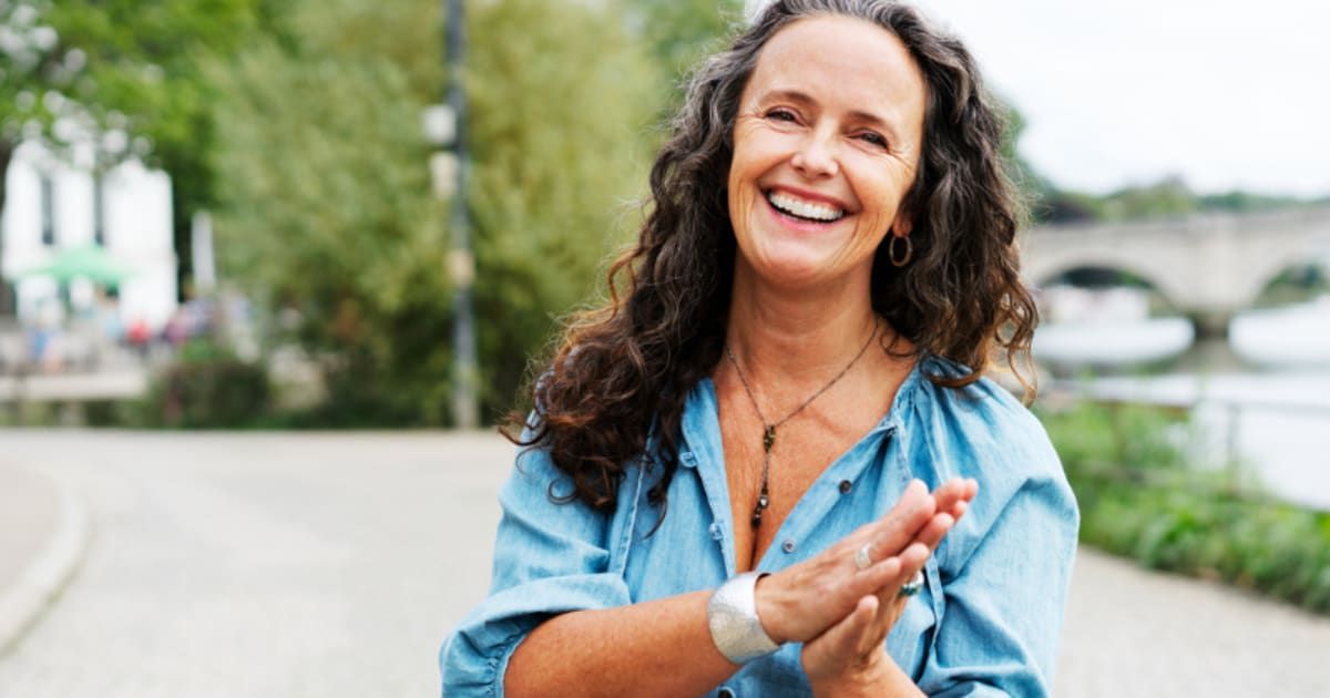 Woman with hands together, smiling. Representative Image Source: Getty Images | Tim Robberts