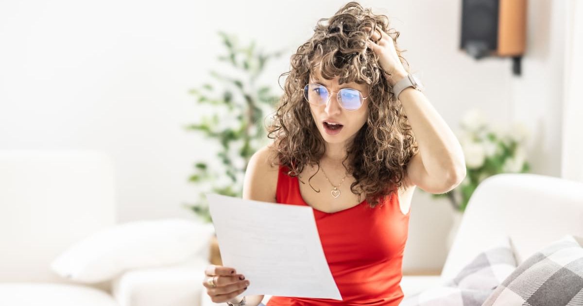 Woman looking at a note with a surprised expression. Representative Cover Image Source: Getty Images | Simple Images