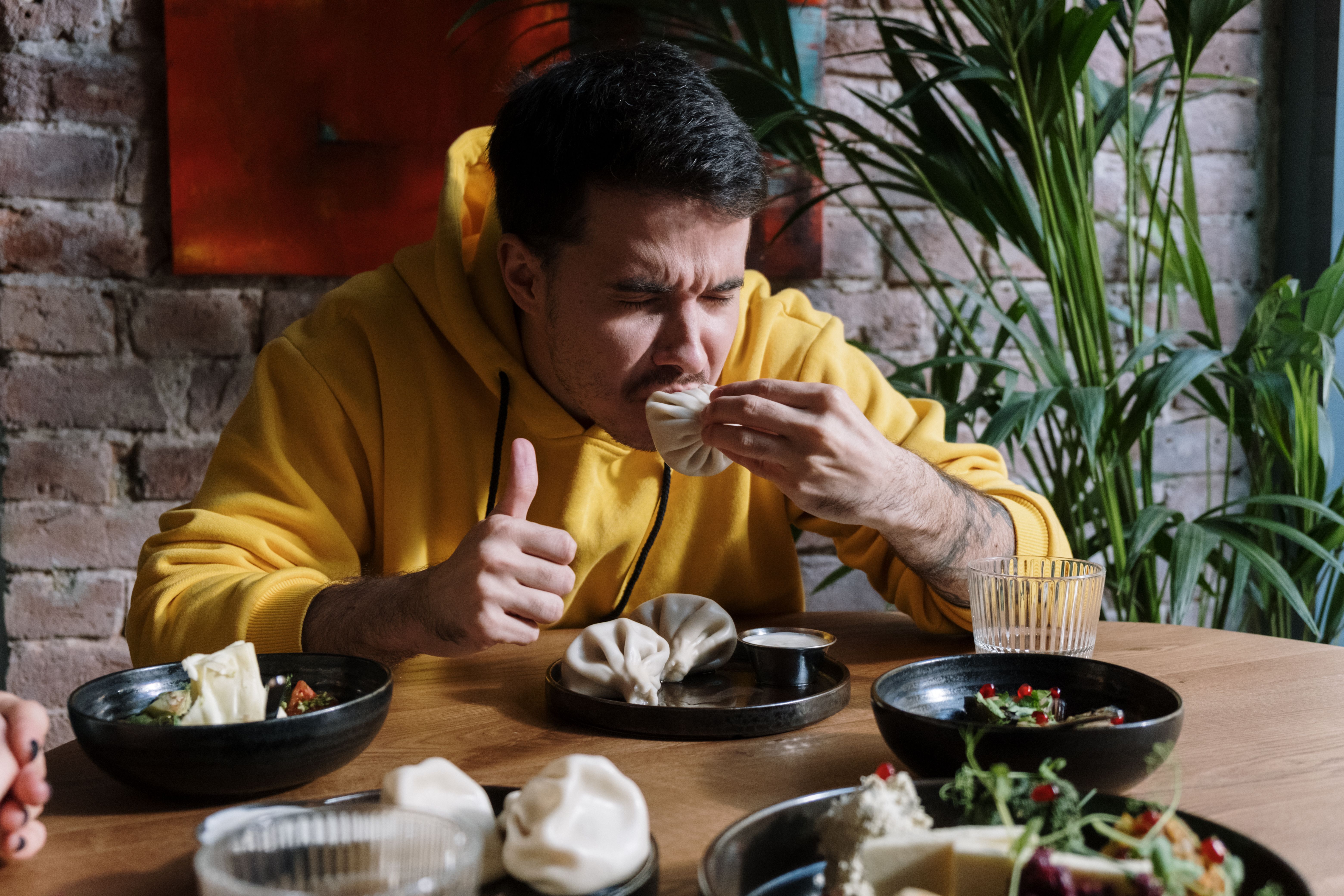 A man is enjoying a meal at a restaurant.