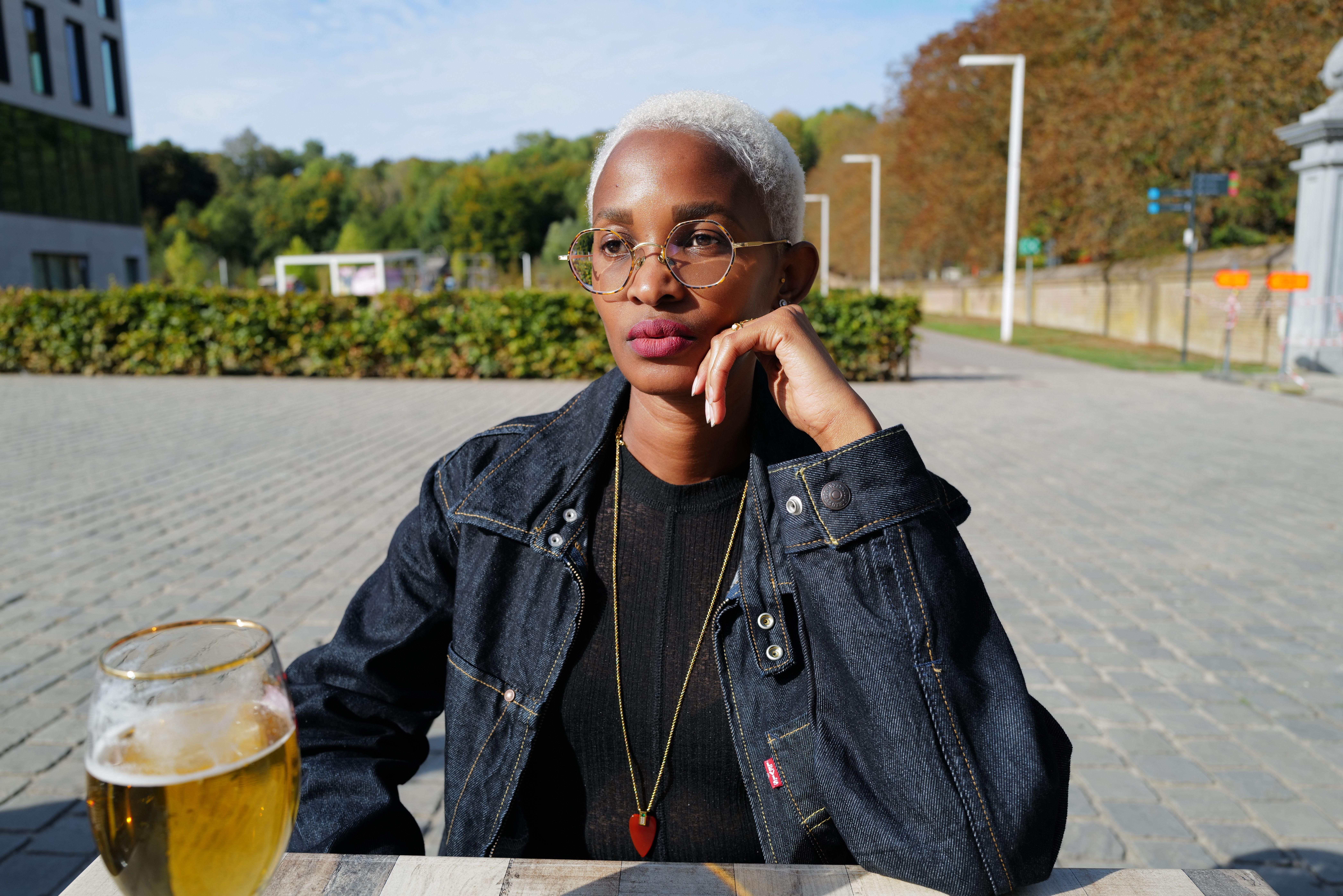 A woman looks disappointed while seated at a restaurant.