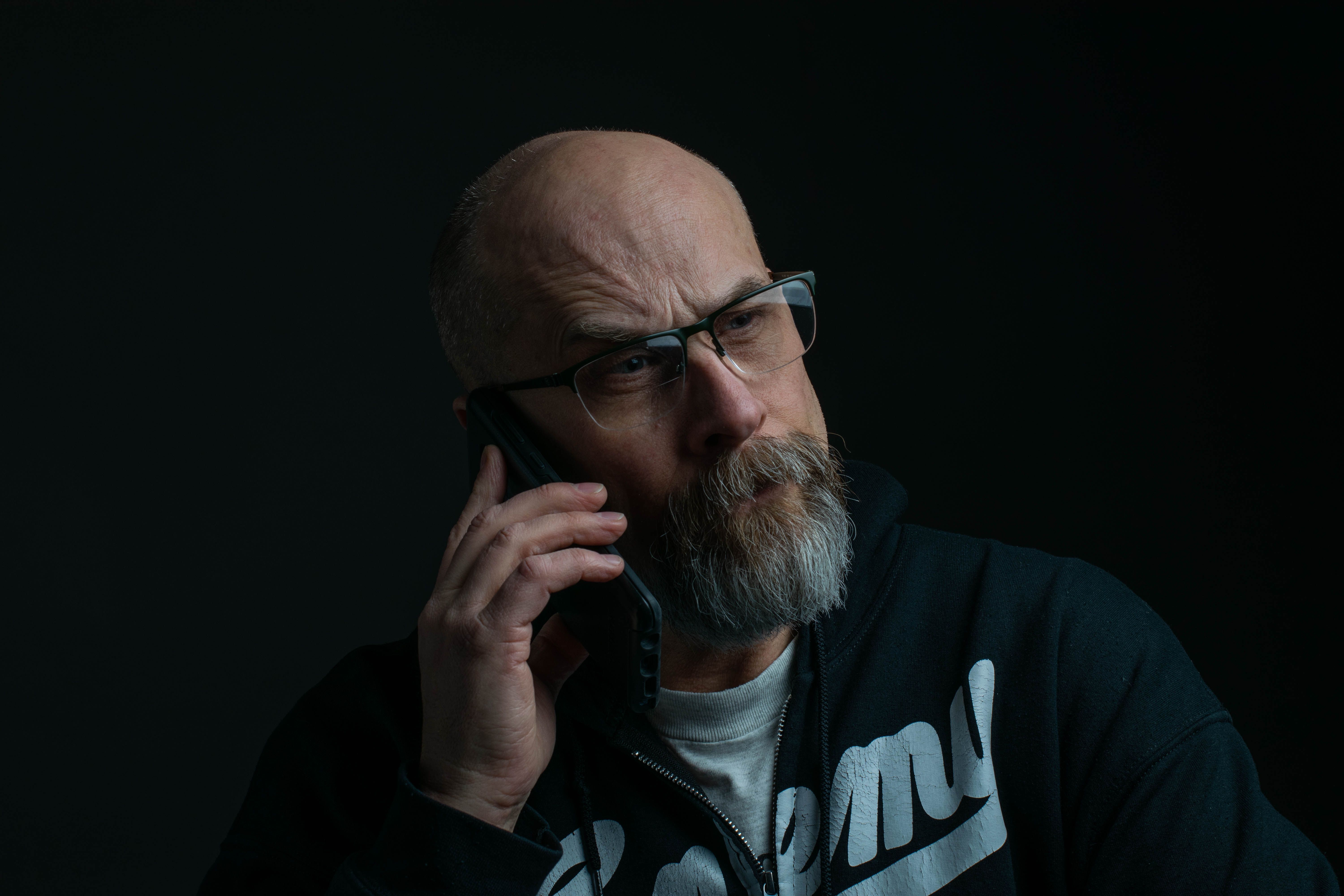 A suspicious man is speaking on the phone.