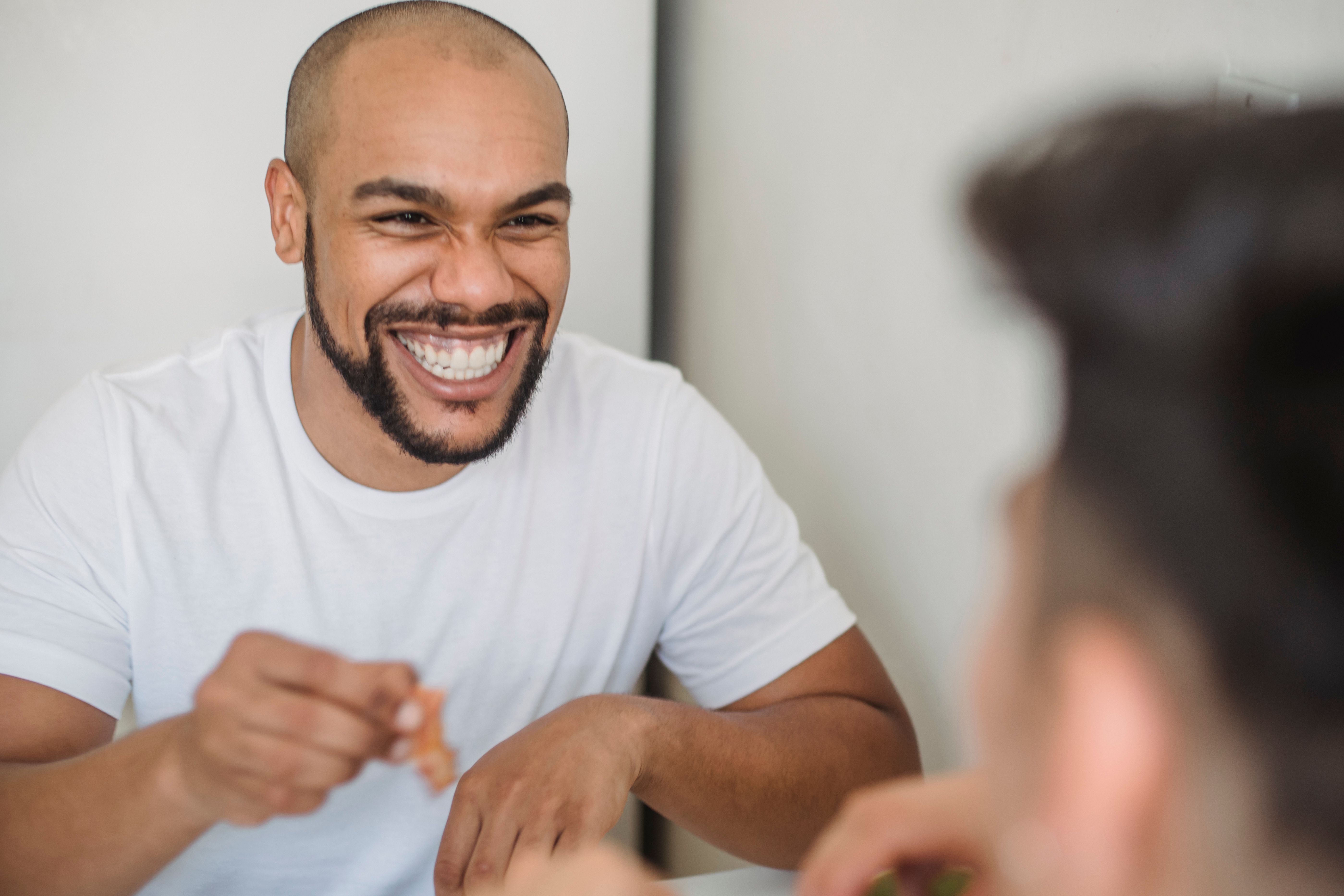 A man is laughing and mocking someone.