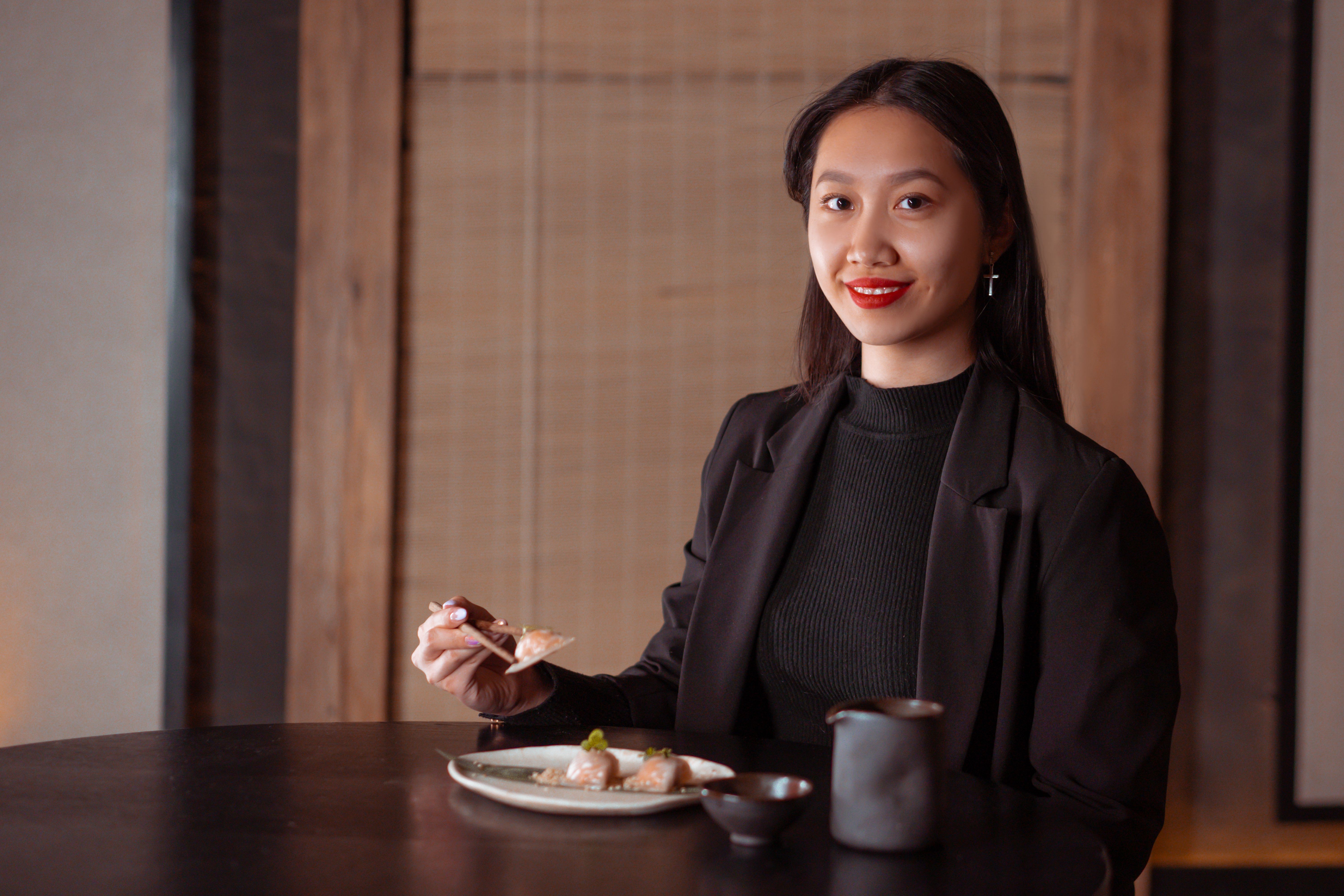 A woman is eating at a restaurant.