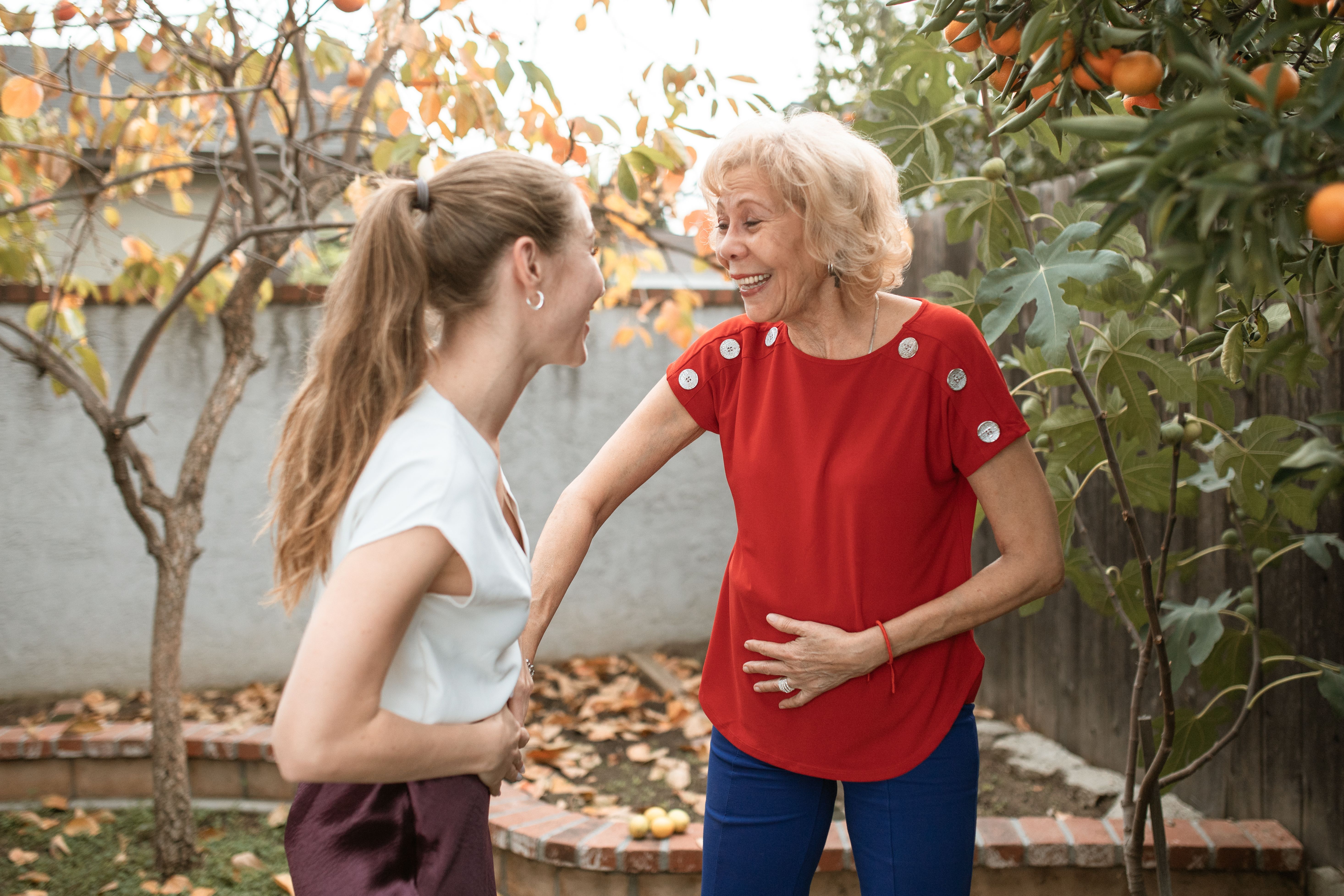 A woman talking to her mother-in-law and laughing.