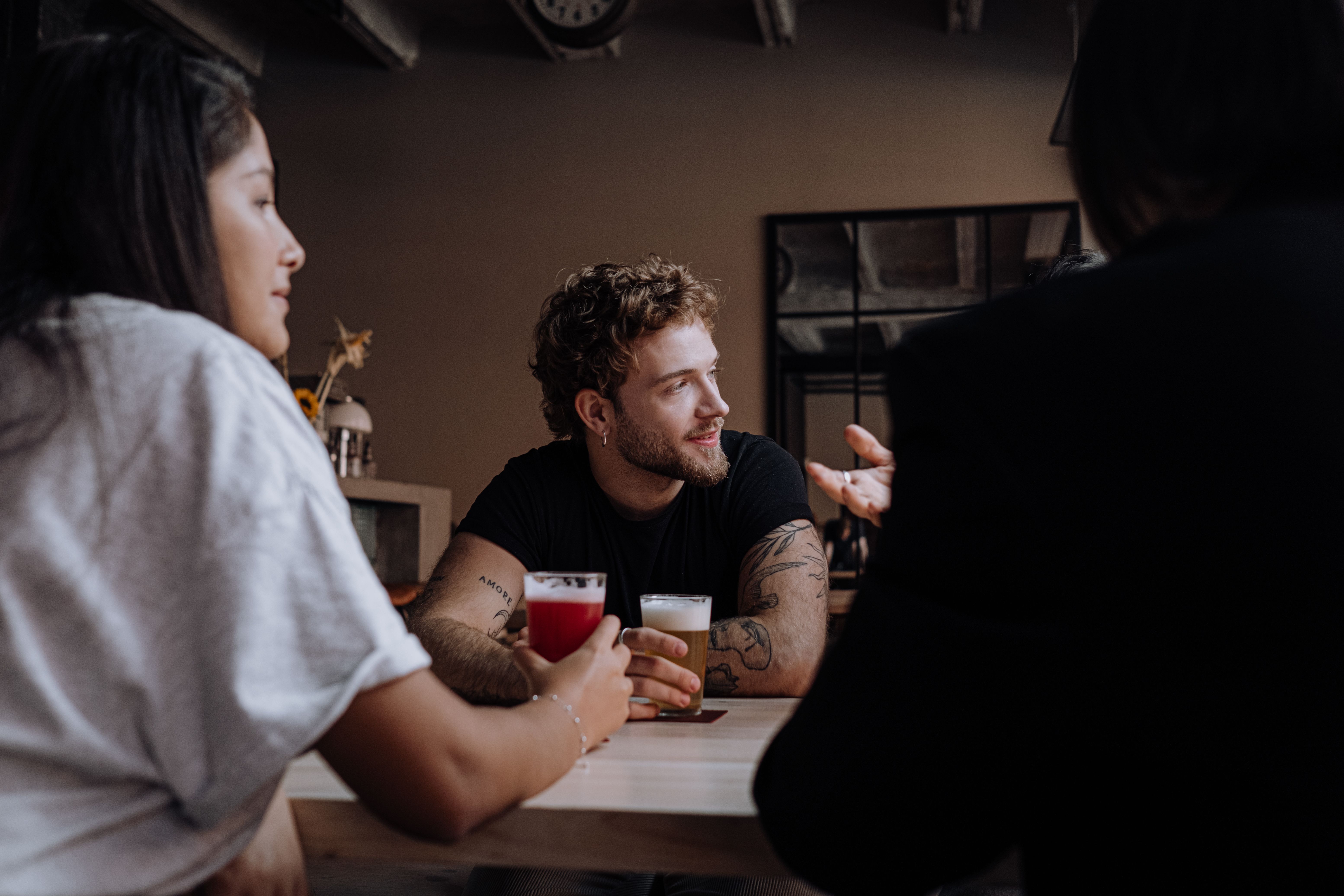 A man looks at someone at a bar.