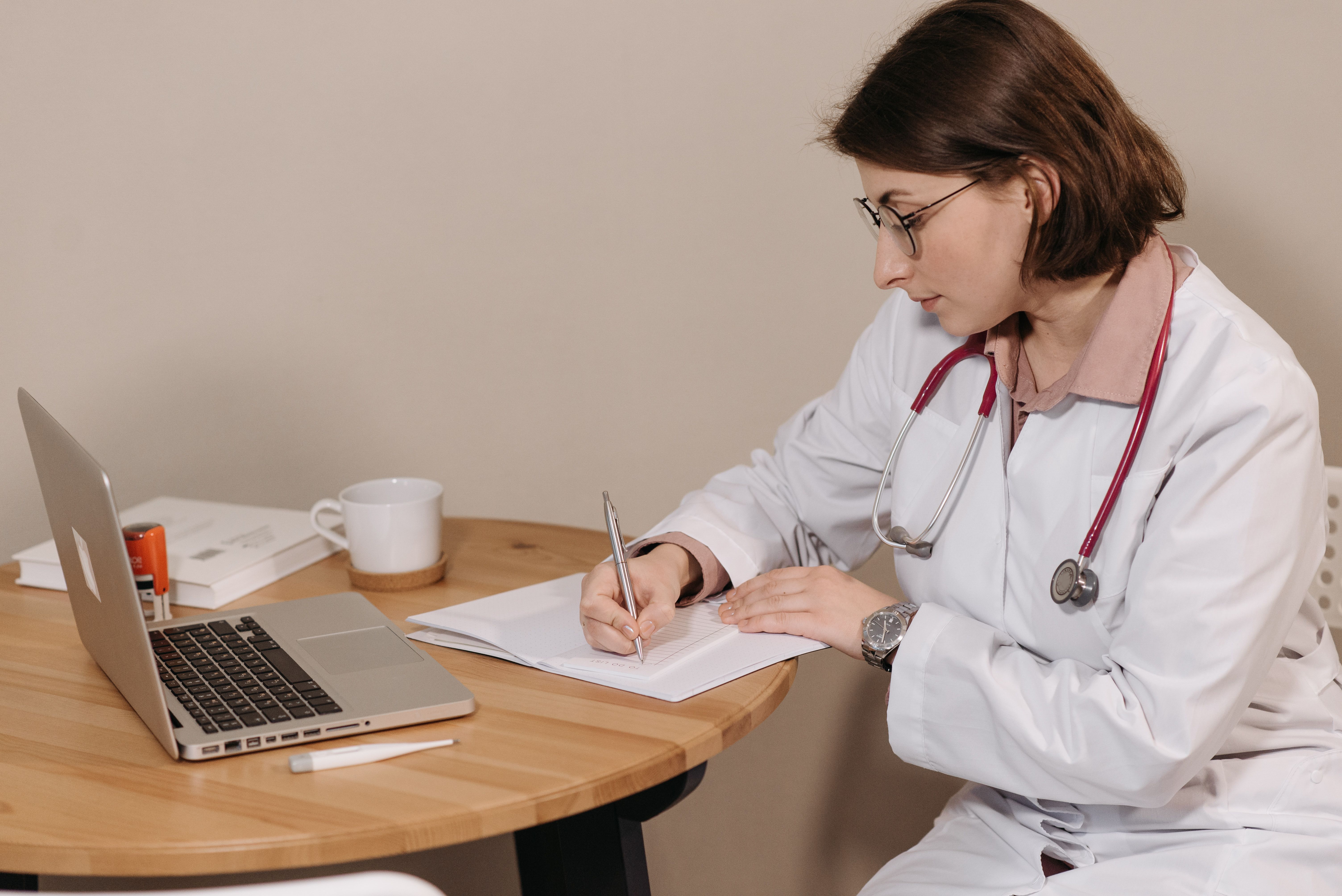A doctor is writing a prescription.