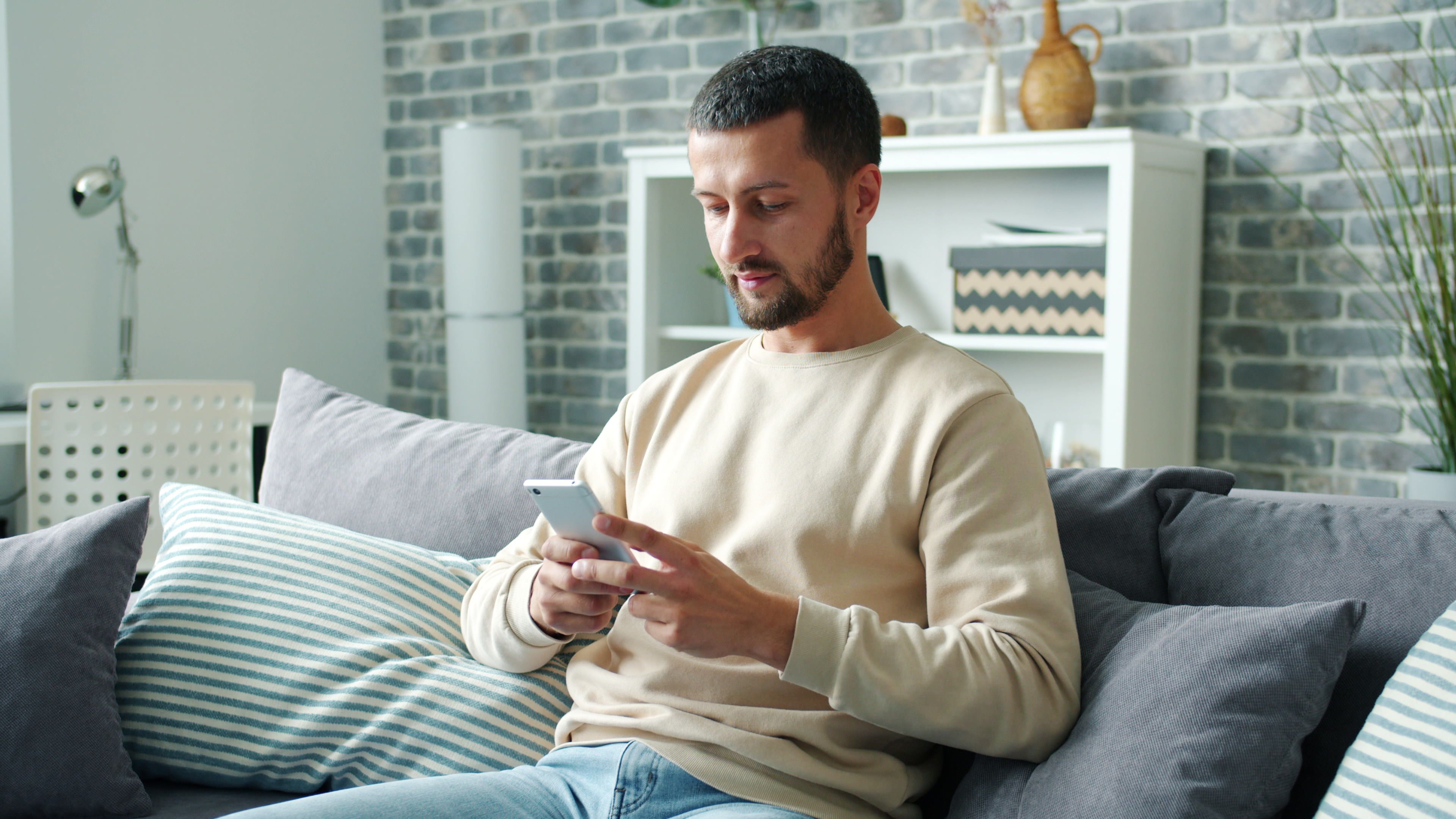 A man is texting someone on his phone.