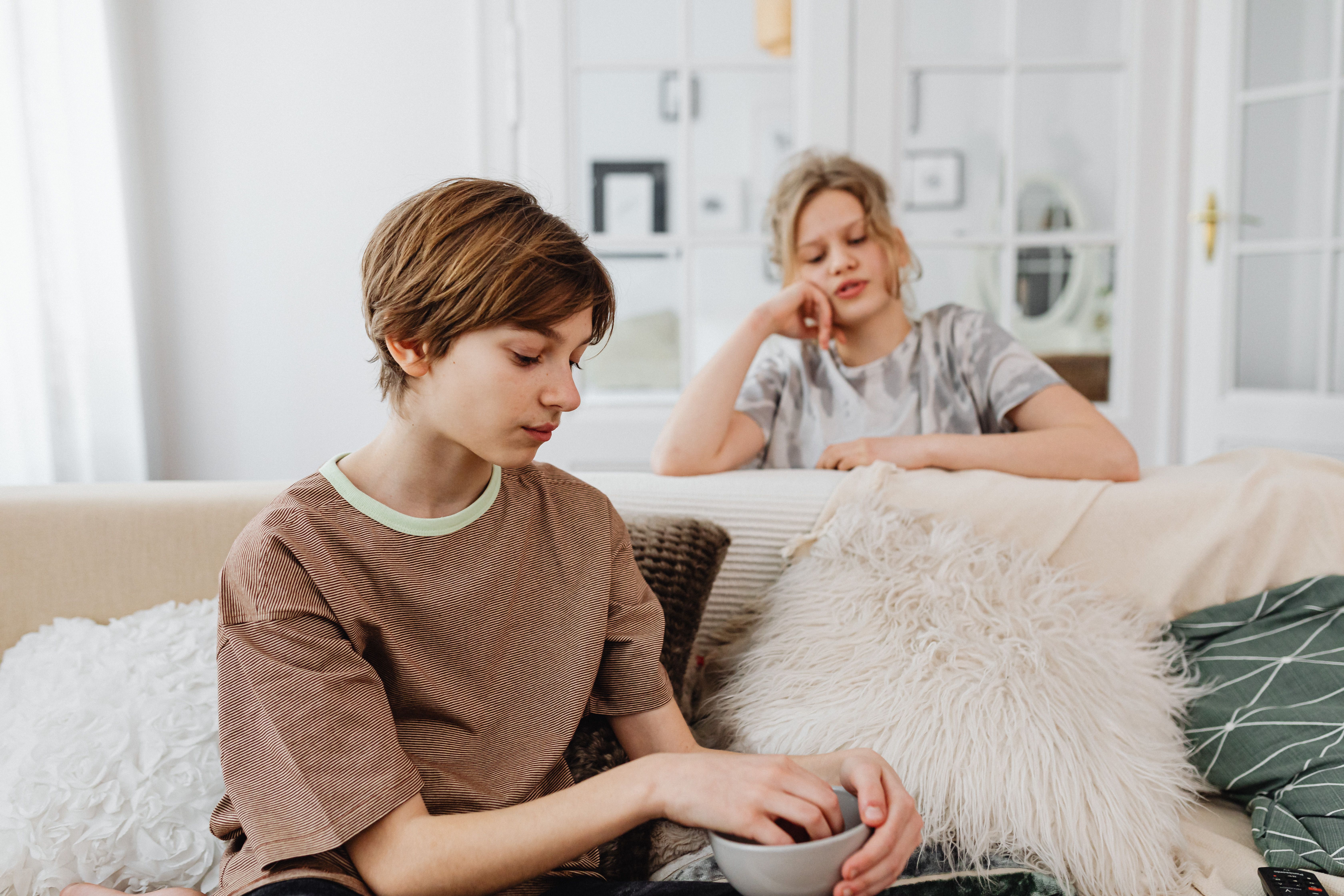 Two teenage girls look upset and insecure.