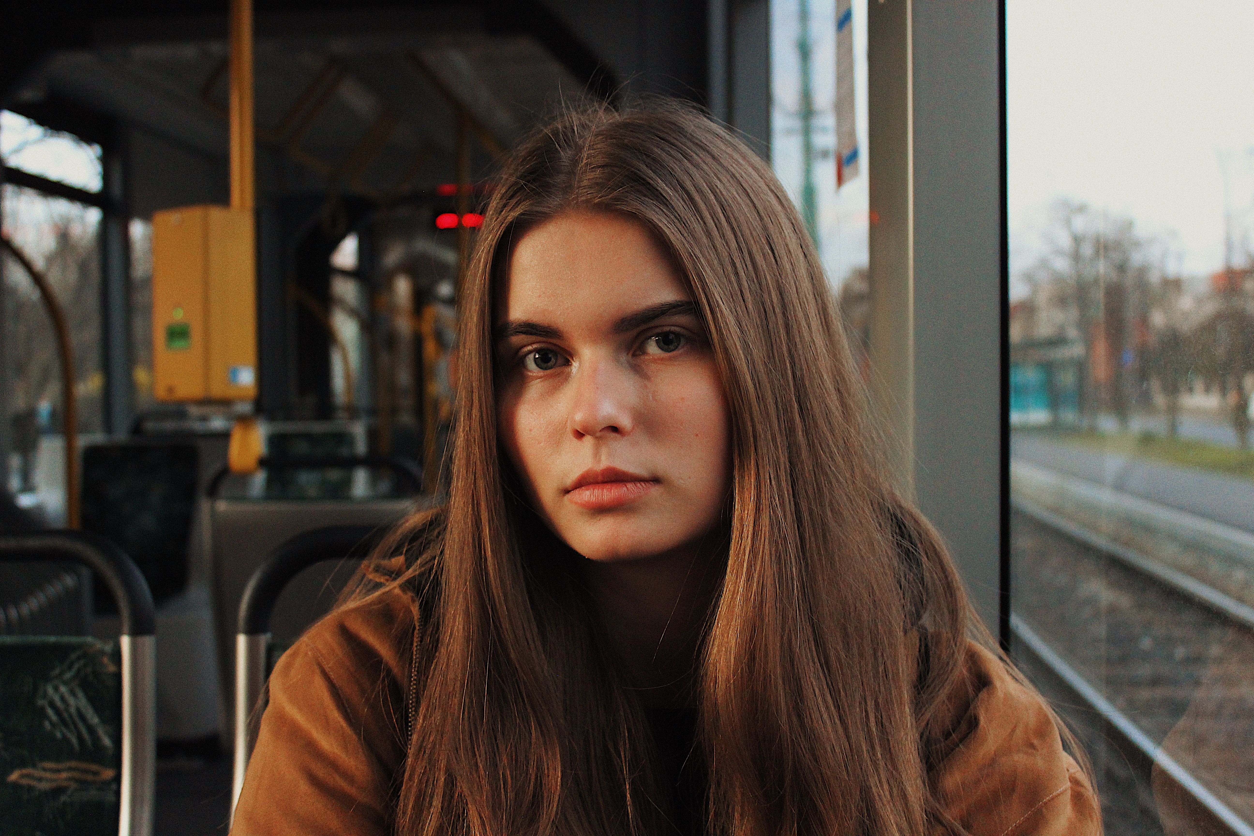 A woman in a train looks annoyed.