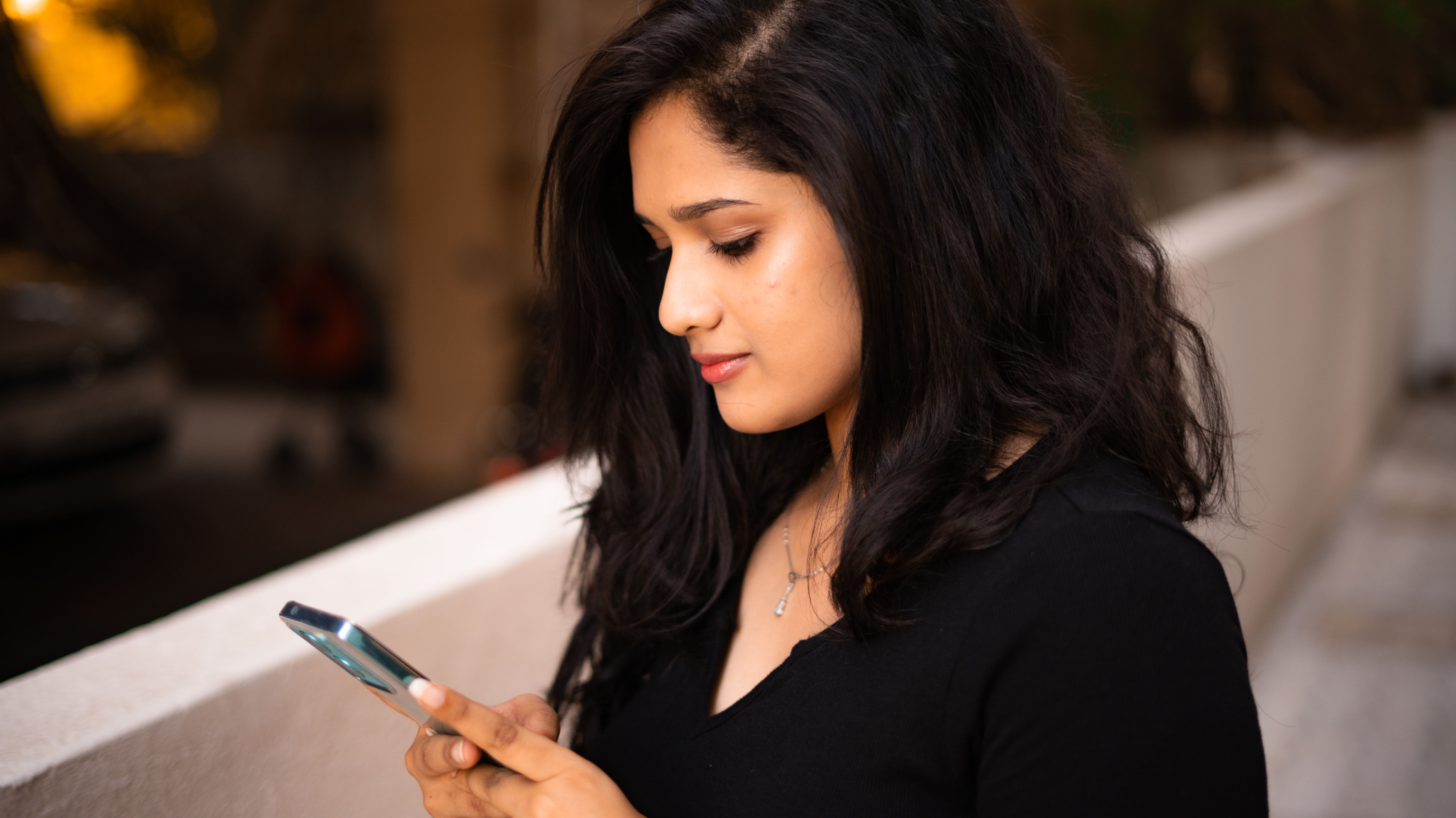 A woman is texting on her phone.