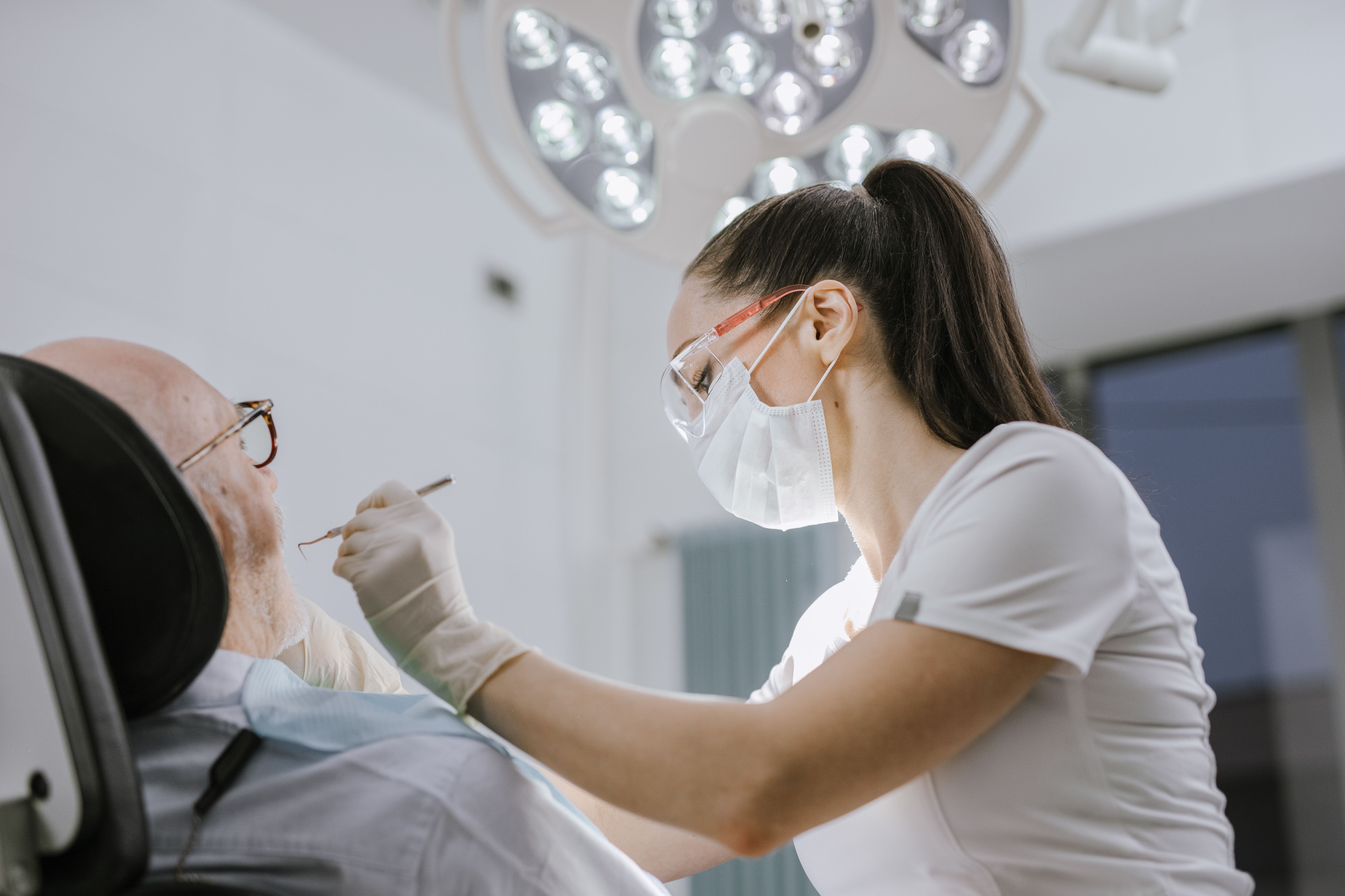 A dentist focused on treating patient.
