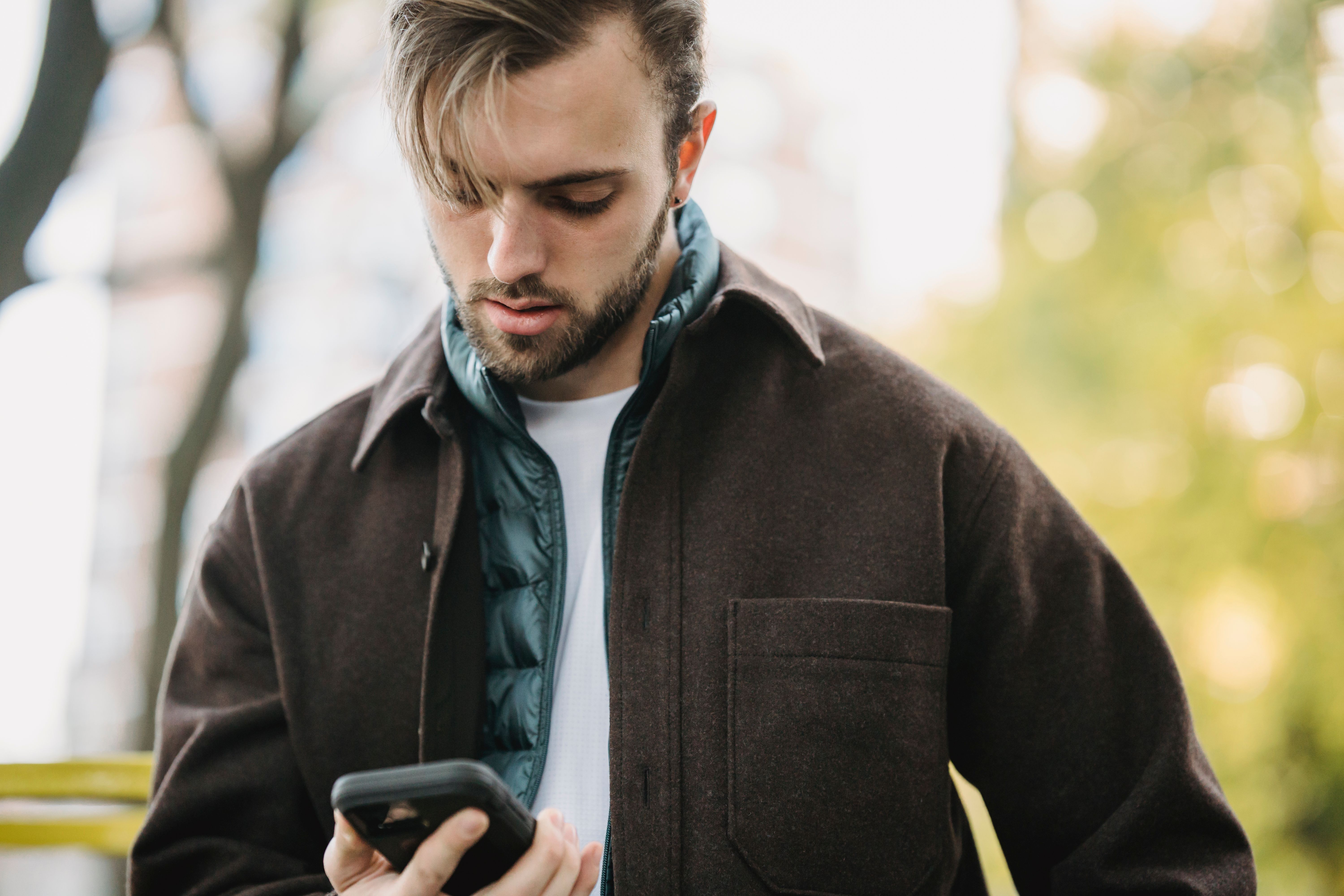 An angry man looking at his phone.