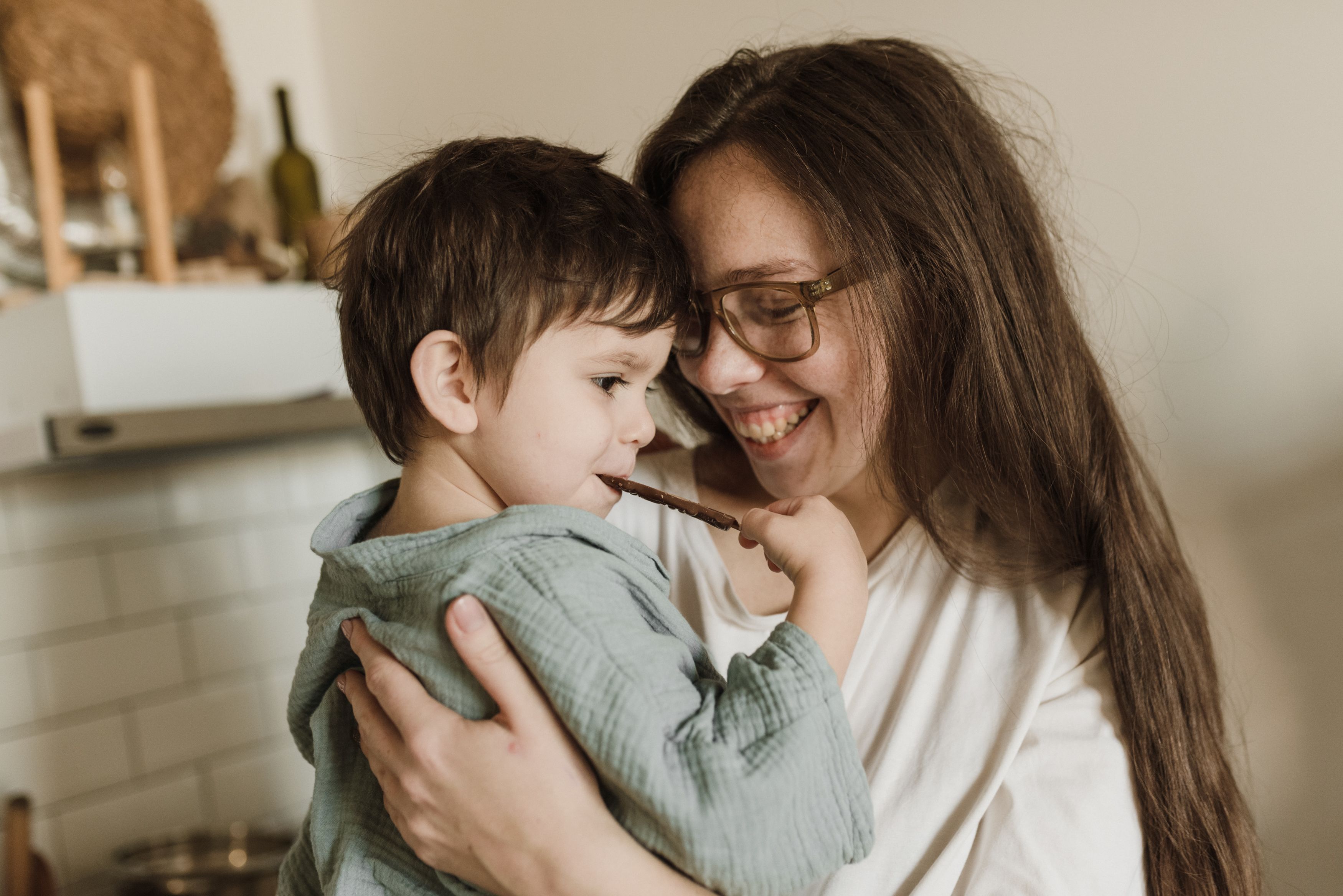 A mom hugging her son.