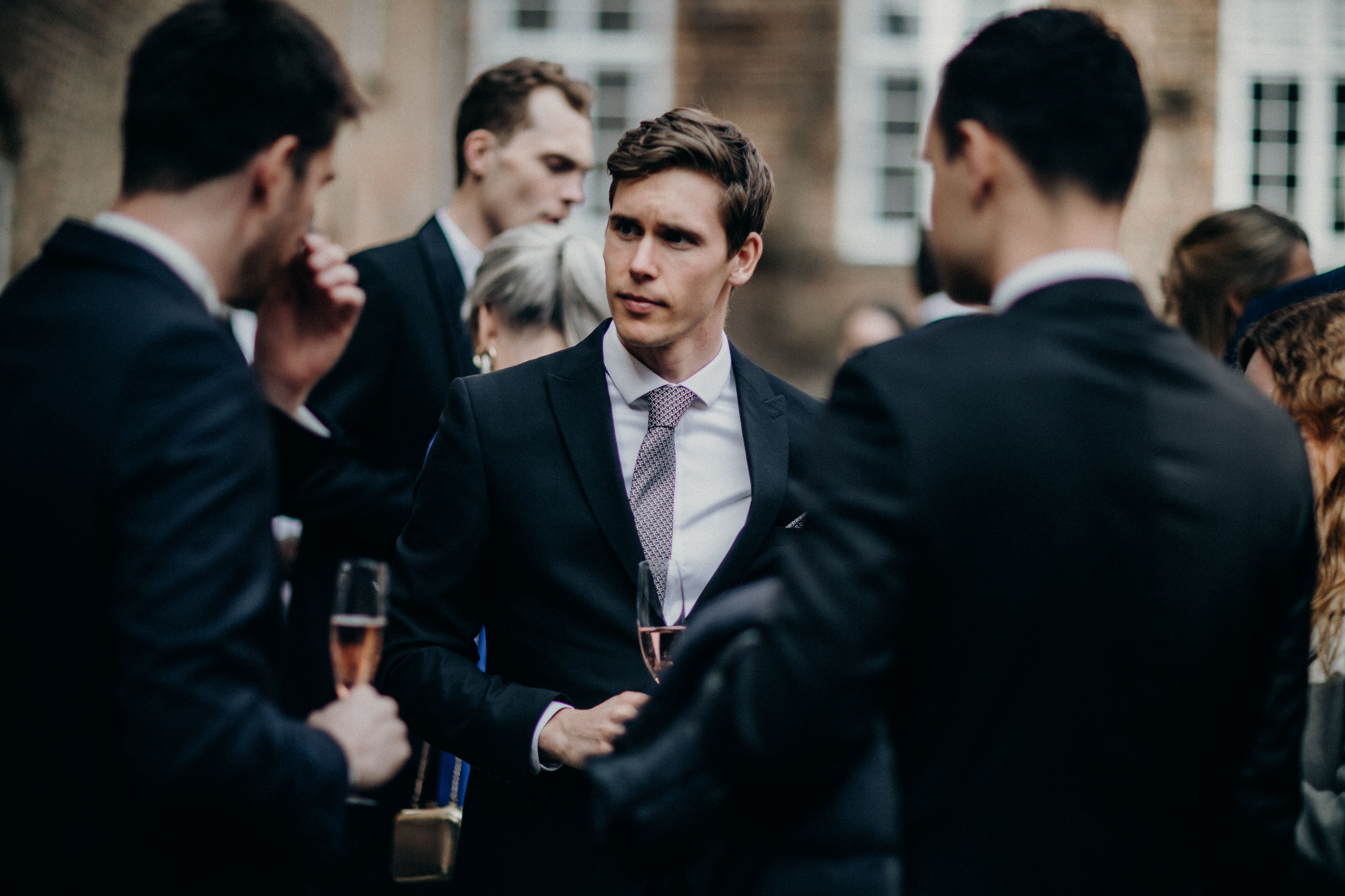 A man looks disappointed while attending a party.