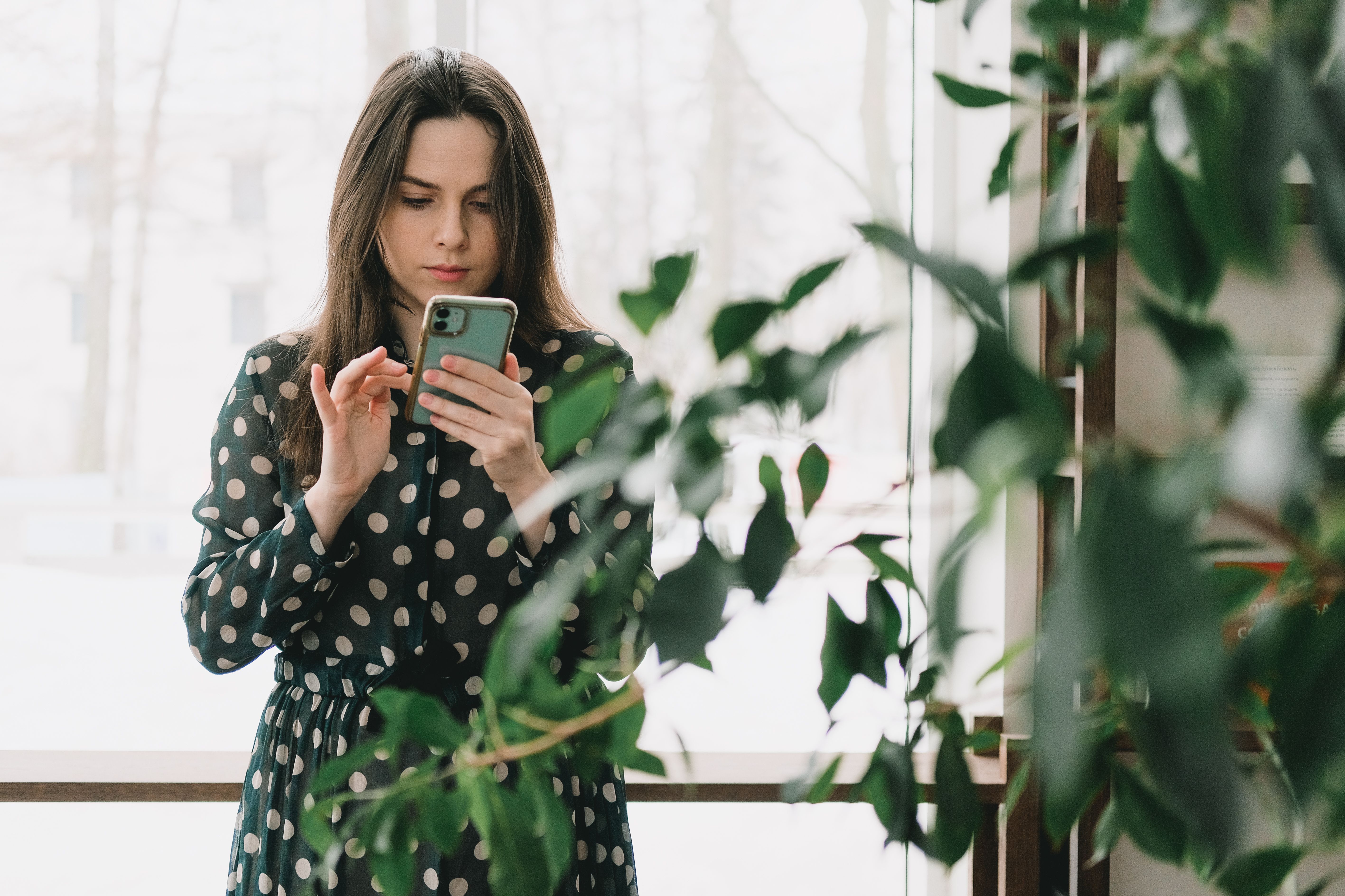A woman is checking a phone.