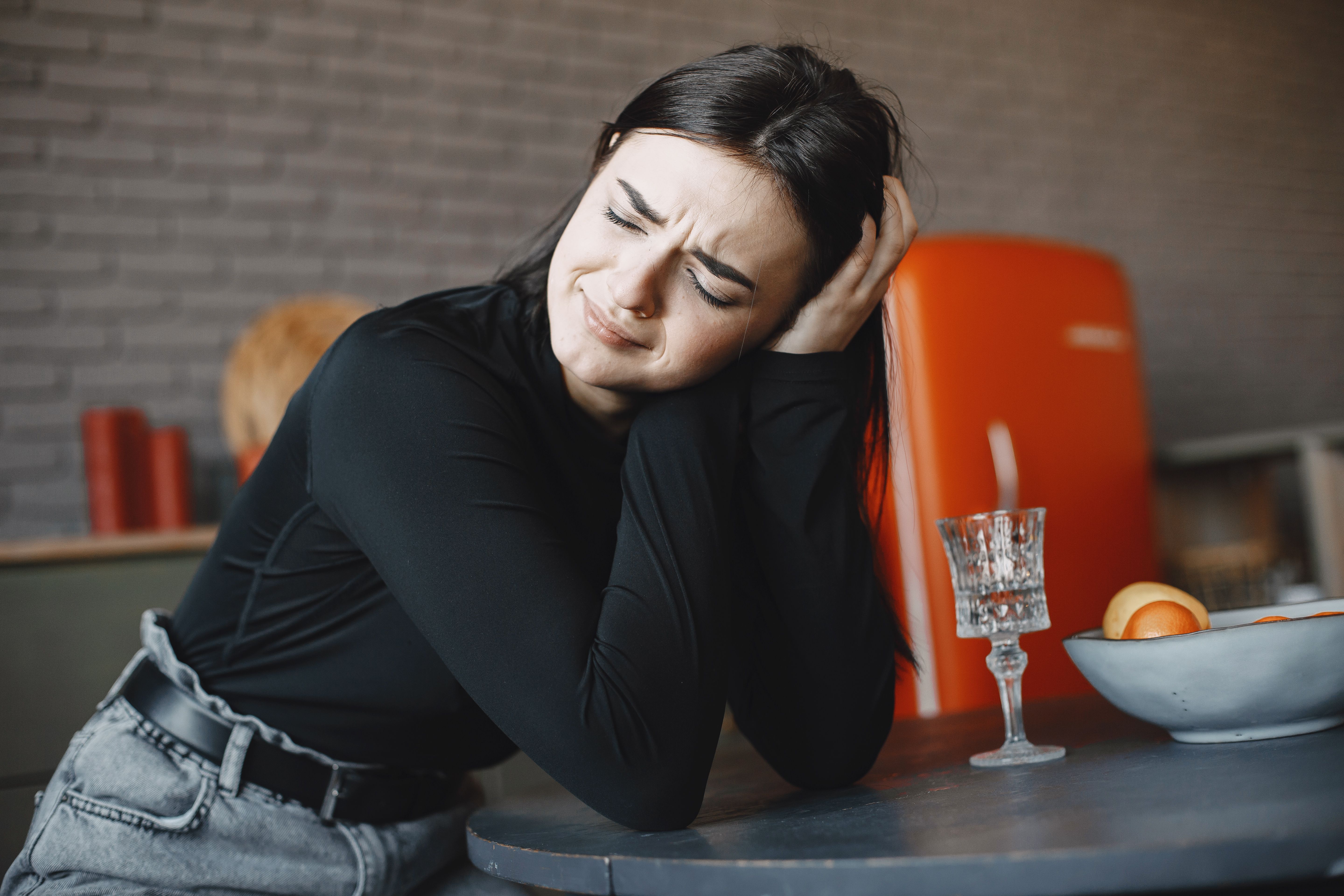 A woman is feeling heartbroken and on the verge of tears.