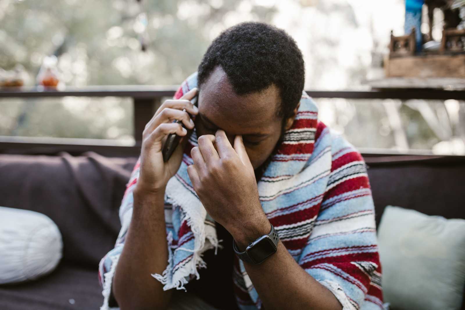 A man looks frustrated as he speaks on call.