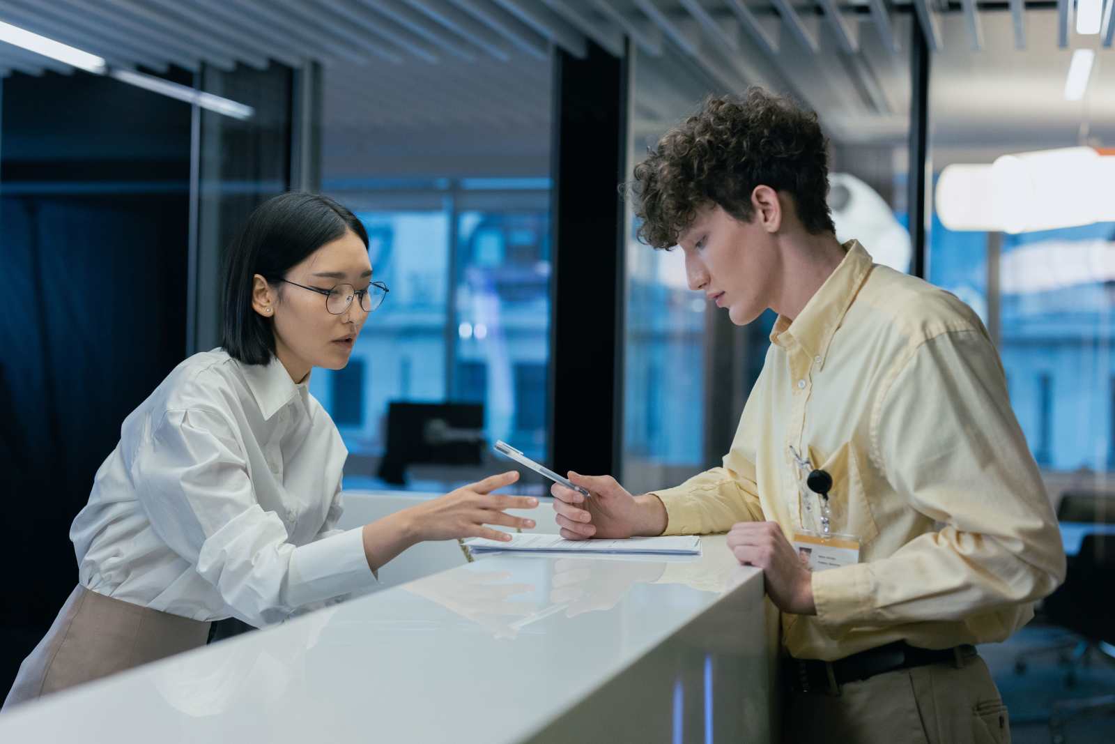 A man speaking with a receptionist.
