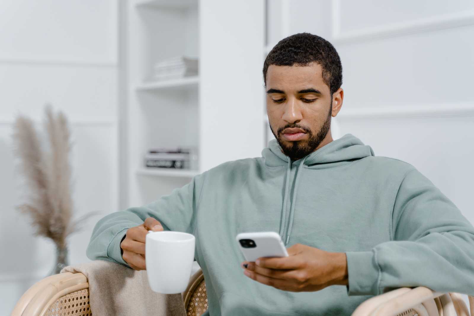 A man looks annoyed while texting.