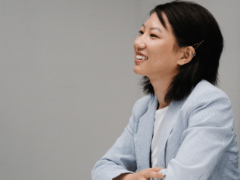 A female employee smiling while talking to somebody.