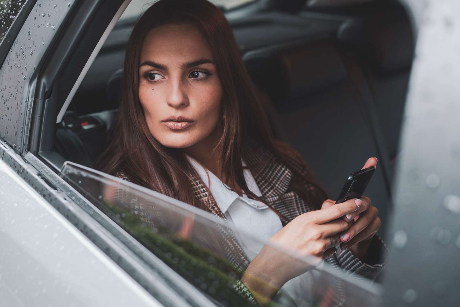 A woman gives a stern stare from her car.