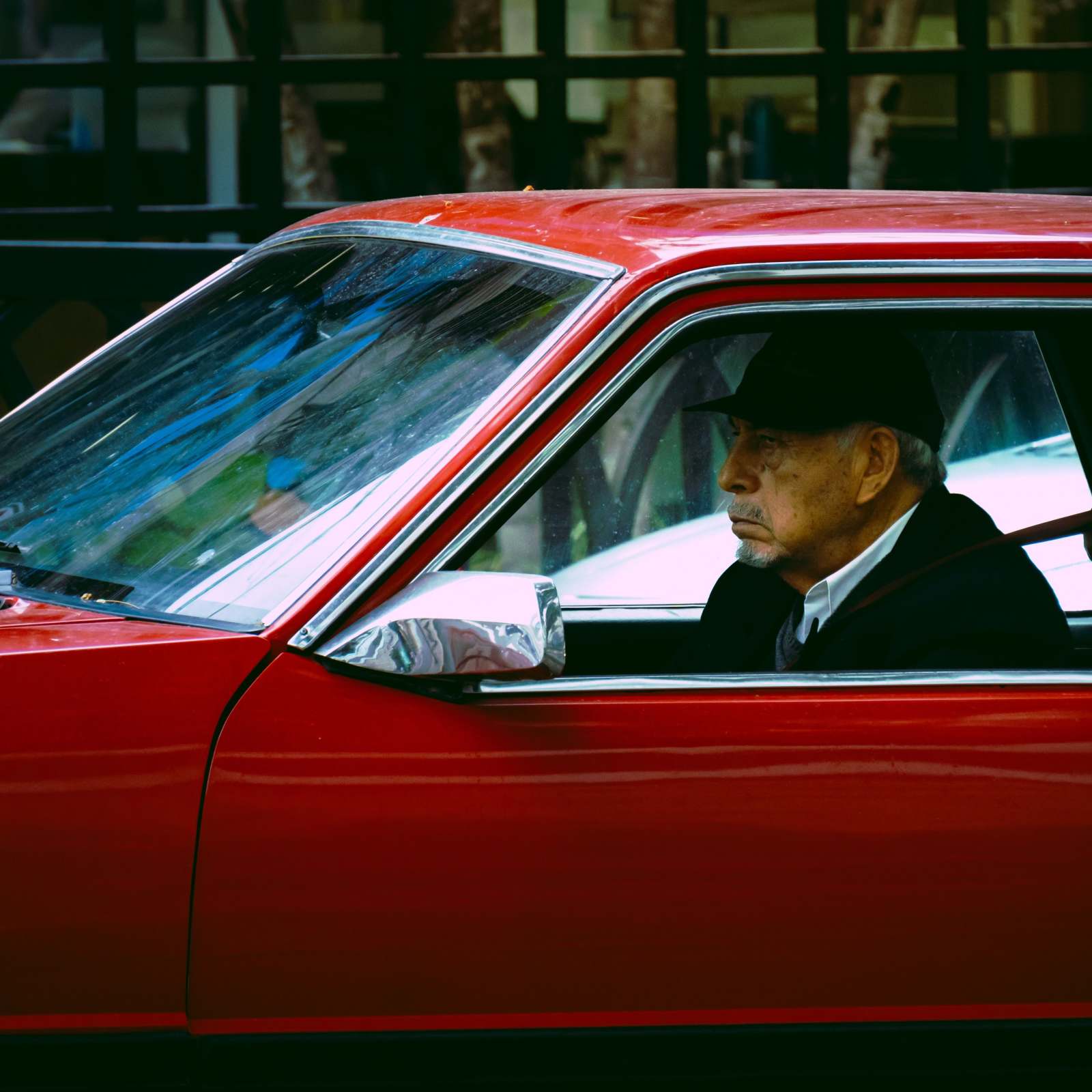 Elderly man driving a vintage red car. (Representative Image Source: Pexels | Johanna M Jaramillo)
