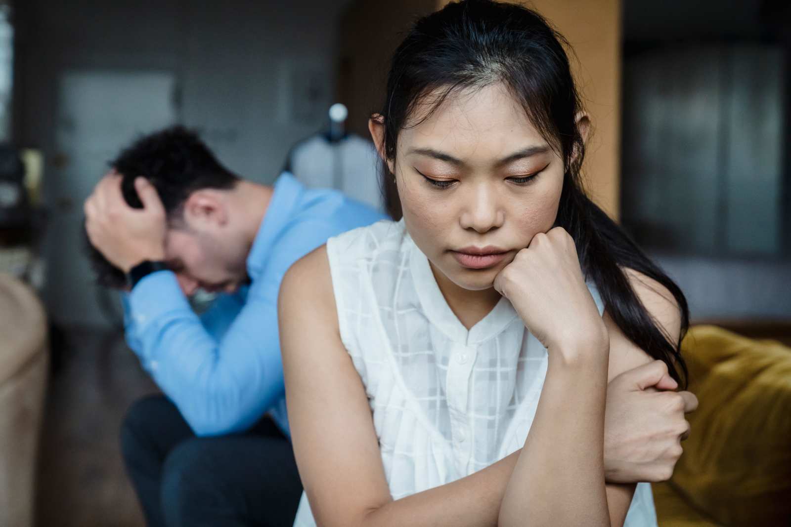 A couple experiencing relationship tension sitting silently on a sofa. (Representative Image Source: Pexels | Timur Weber)