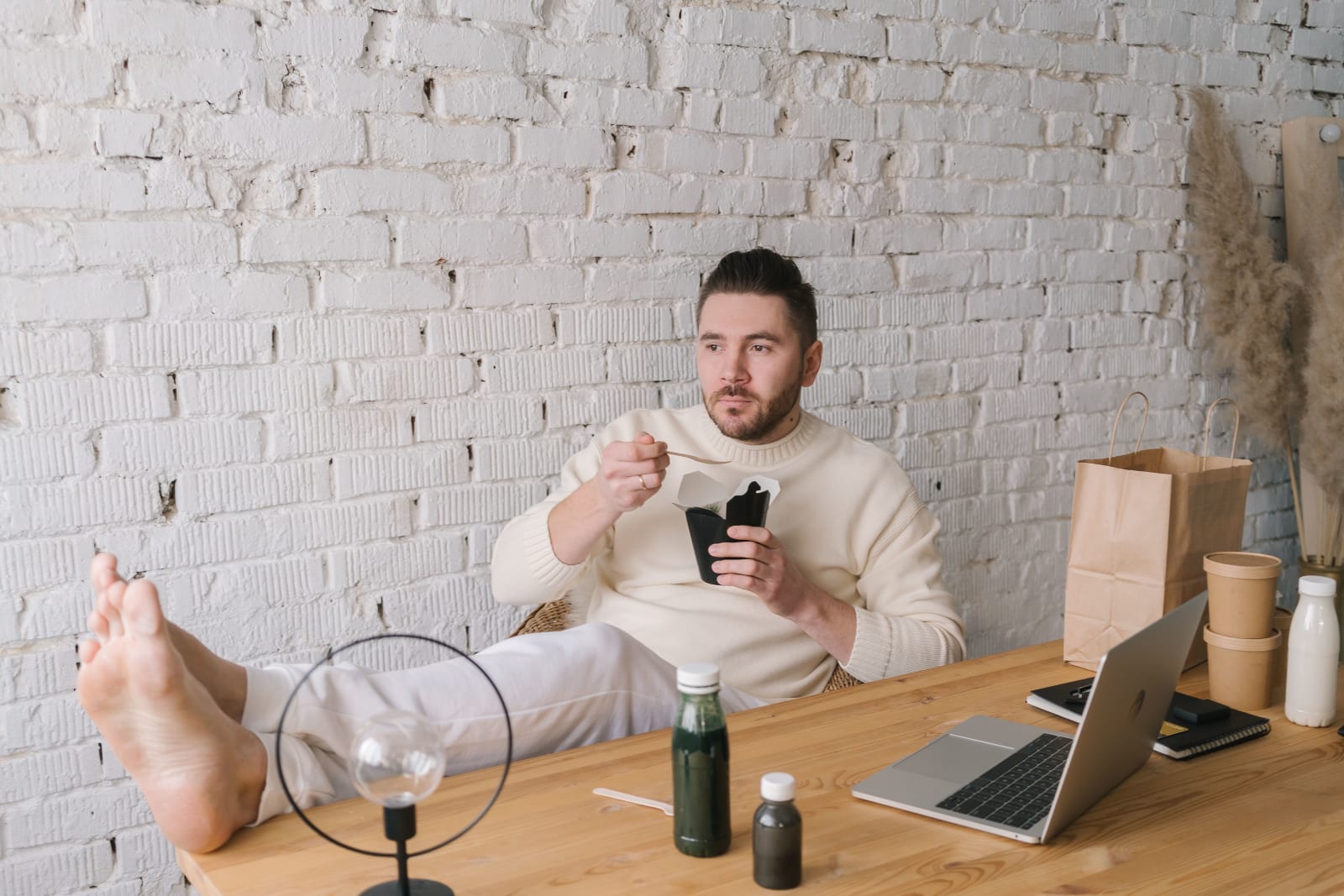 A man is relaxing while working.