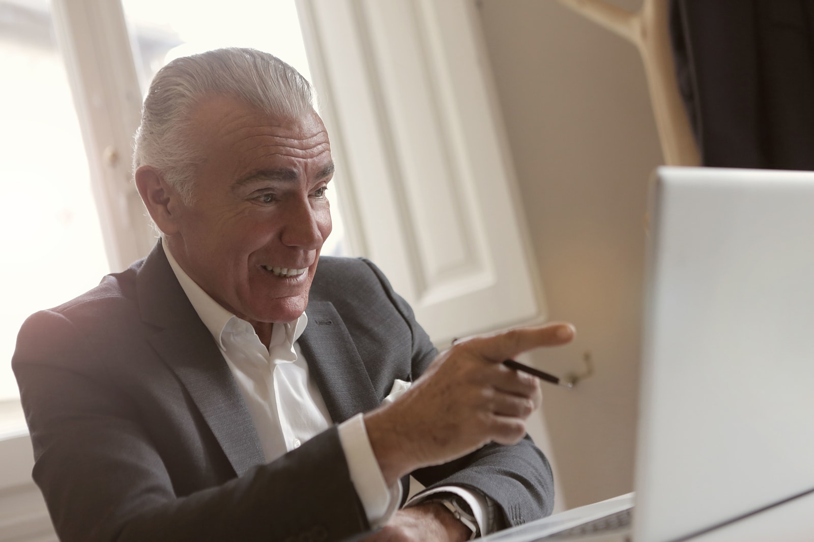 A manager is commending someone during online meeting on laptop.