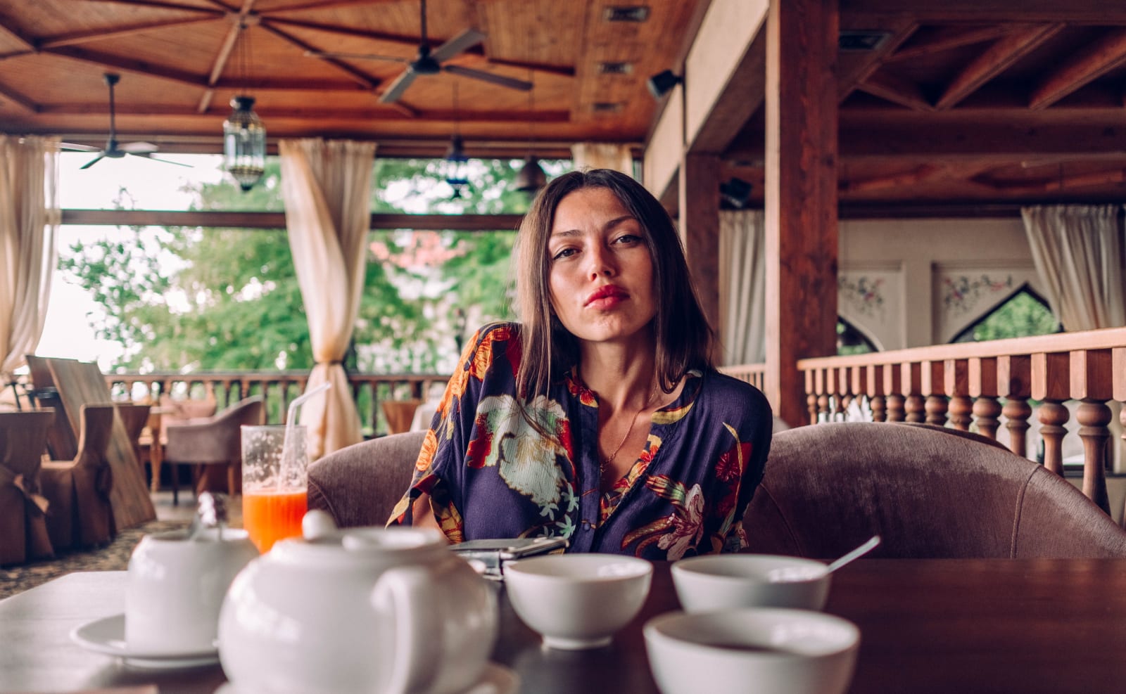 A woman, looking visibly annoyed as a solo diner. (Representative Image Source: Pexels | Igor Starkov)