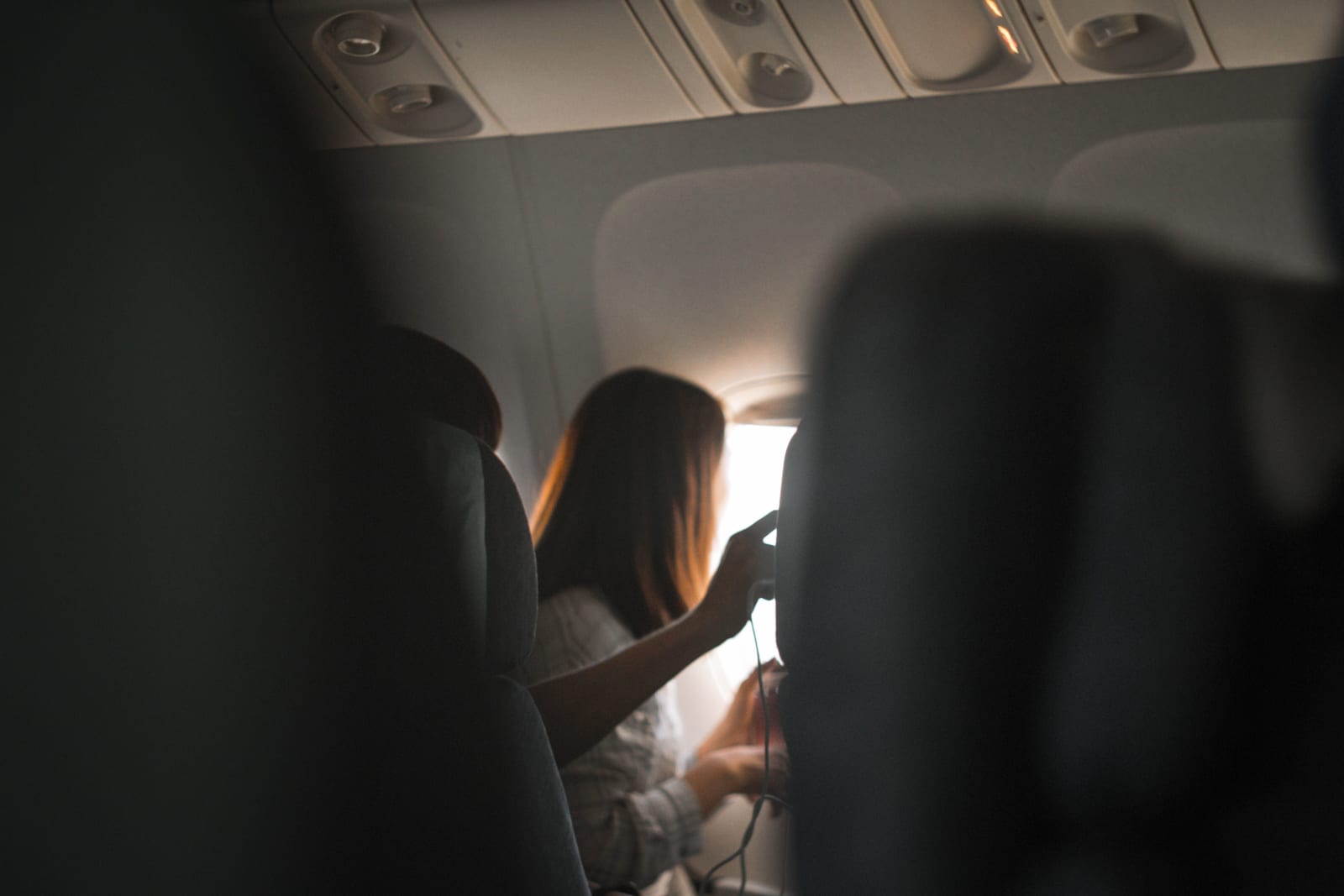 A woman gazes out the airplane window after an argument. (Representative image: Pexels | Sergey Zhumaev)