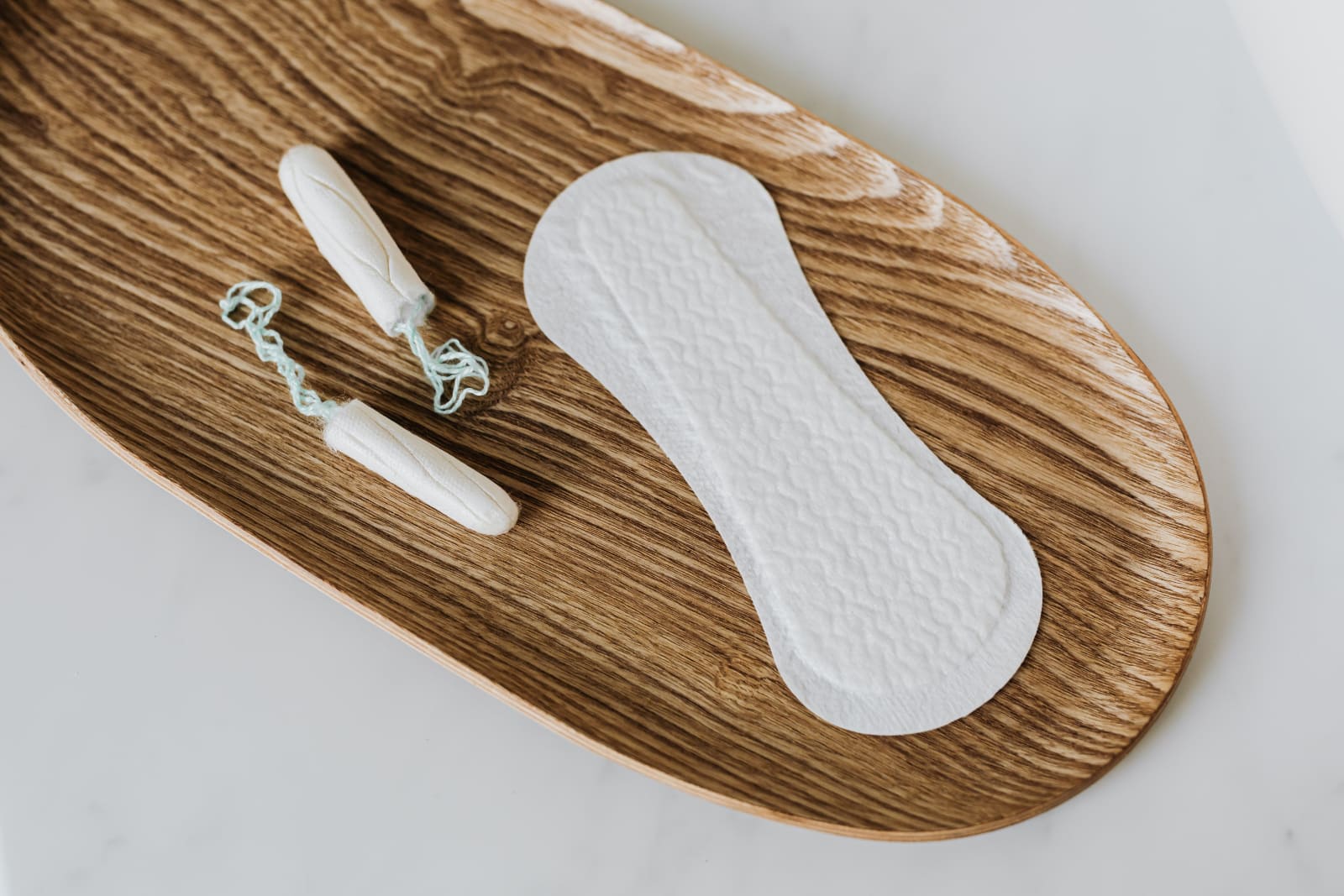 Feminine hygiene products, a tampon and pad.