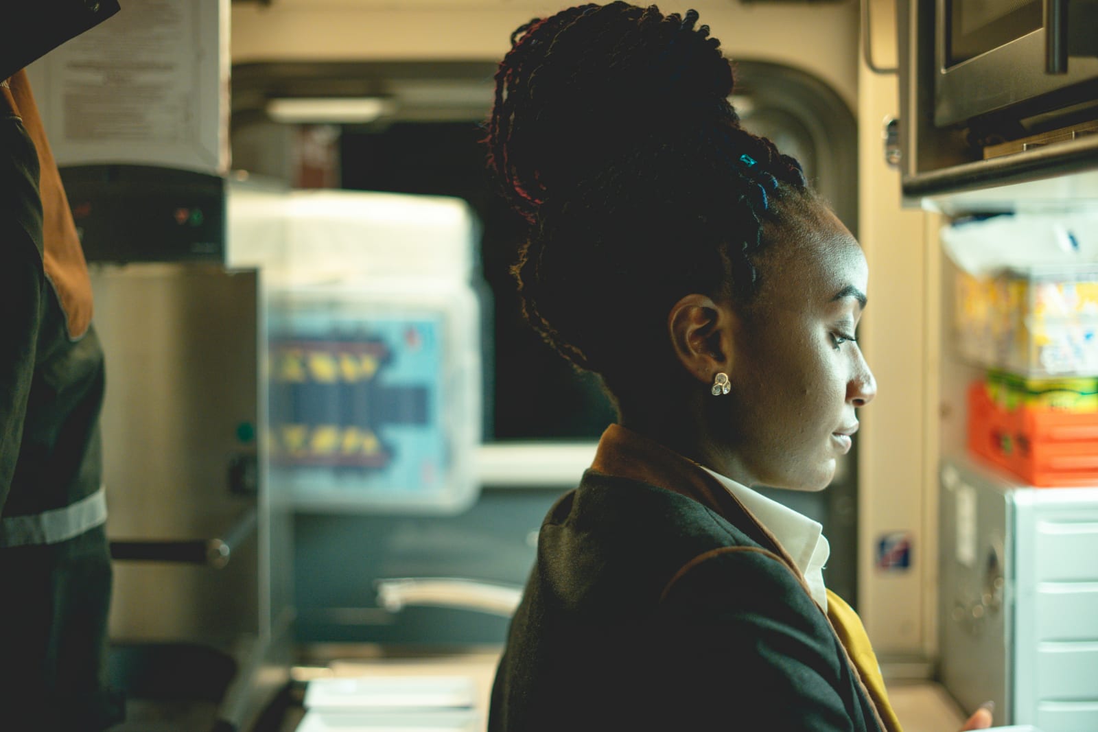 A flight attendant tending to passengers.