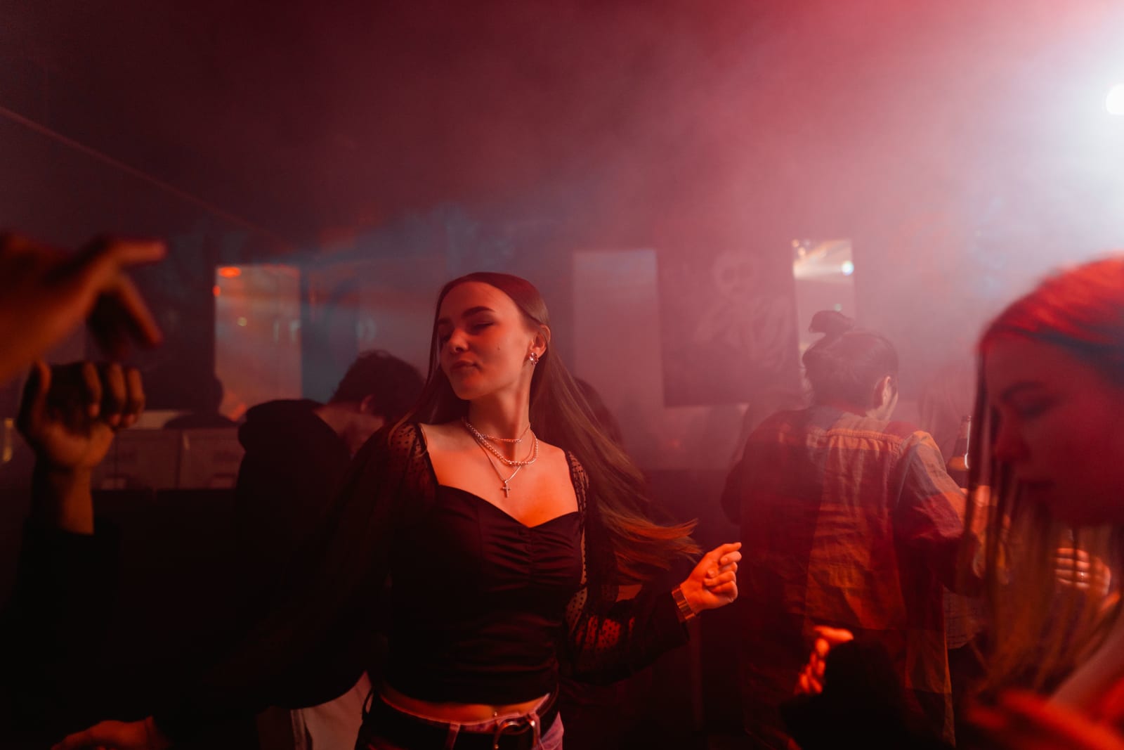 A woman is dancing alone at a club.
