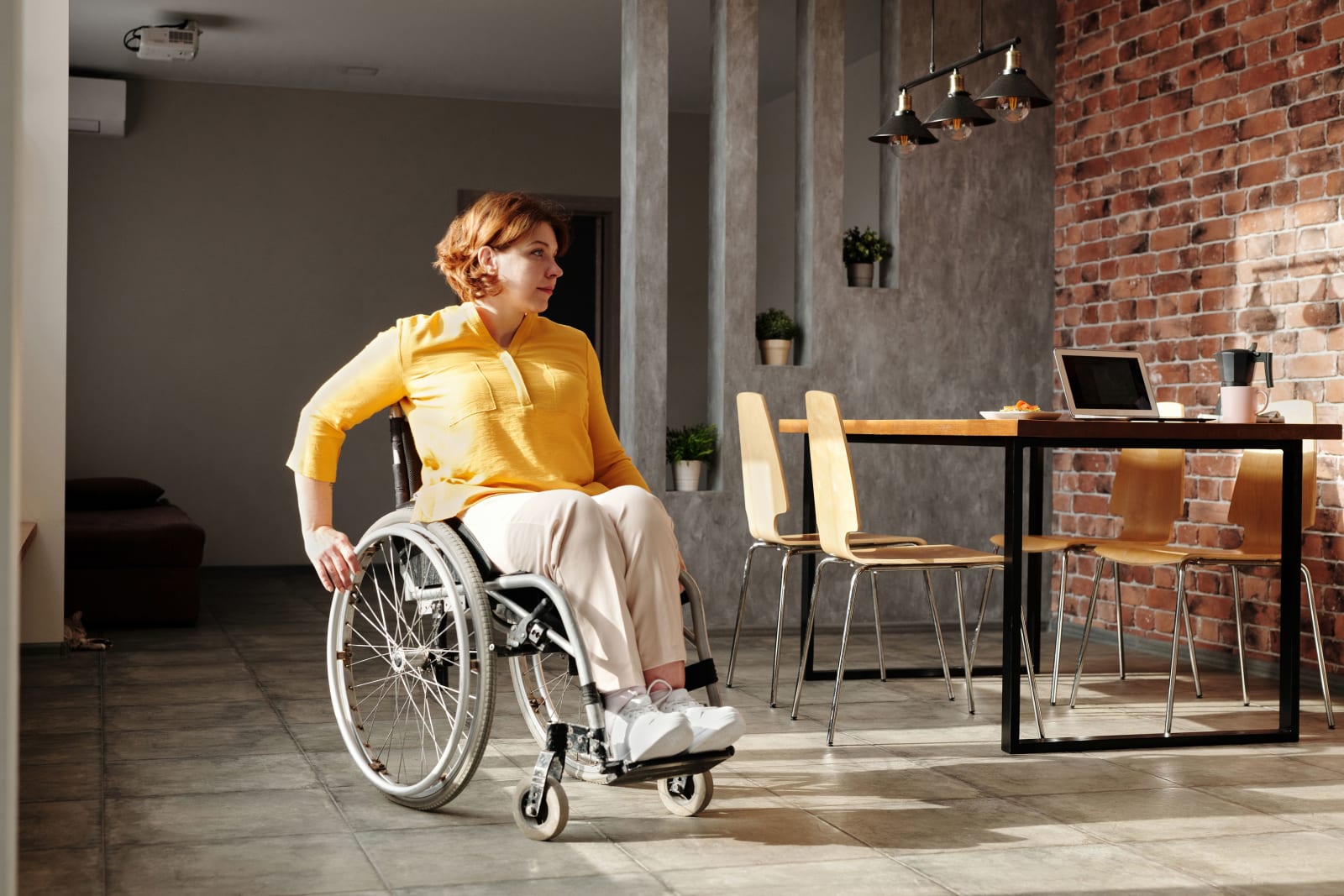 A woman is making her way in a wheelchair.