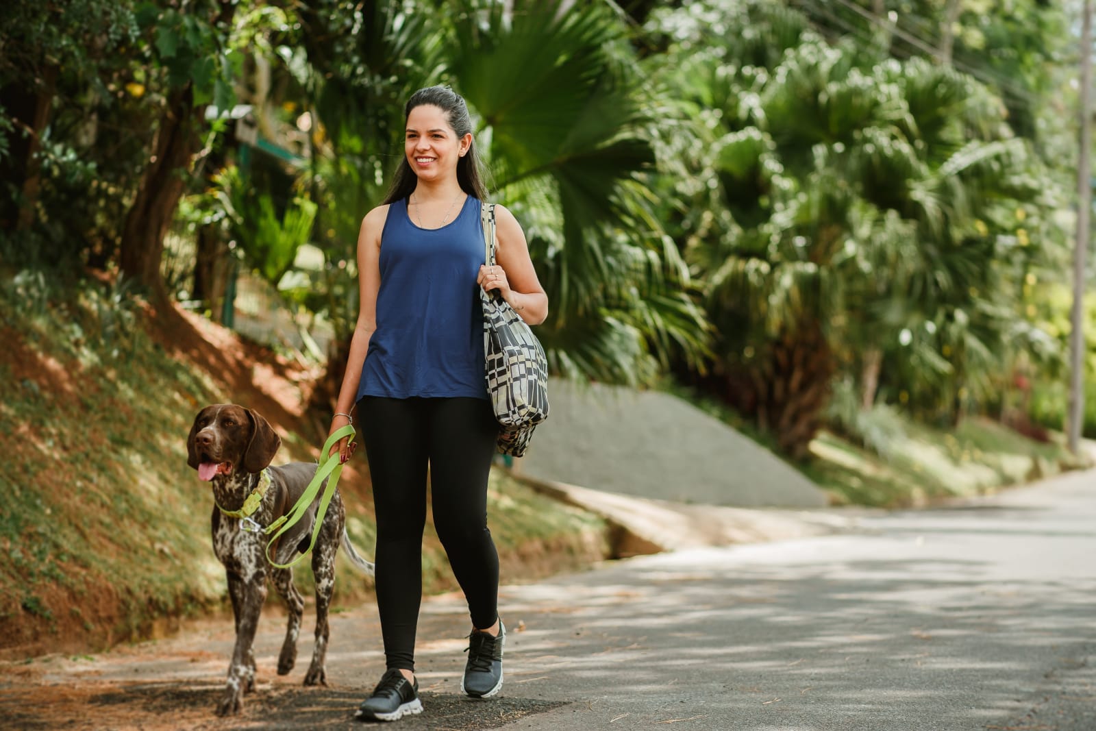 A woman walking her dogs.