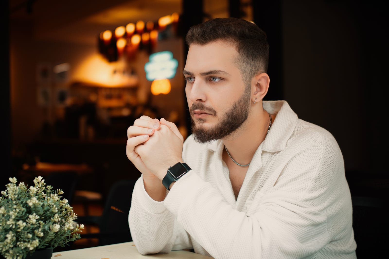 A man looks confused and annoyed at a restaurant.