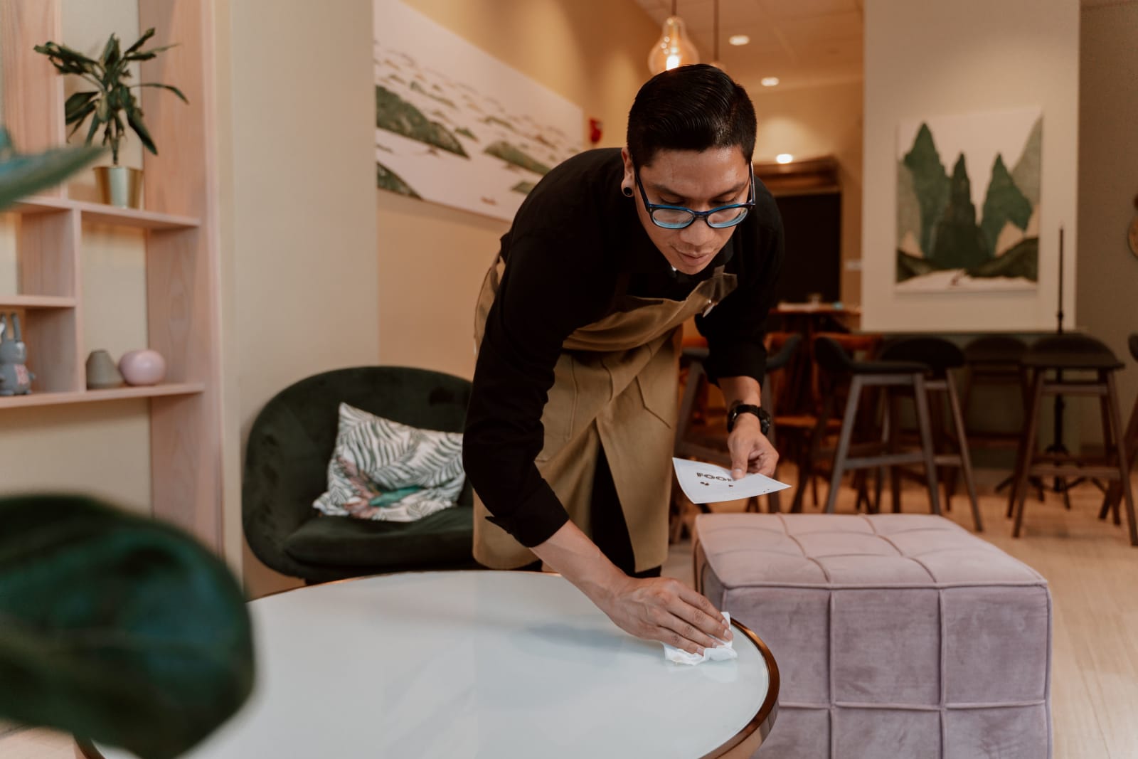 A server looks nervous while clearing table.