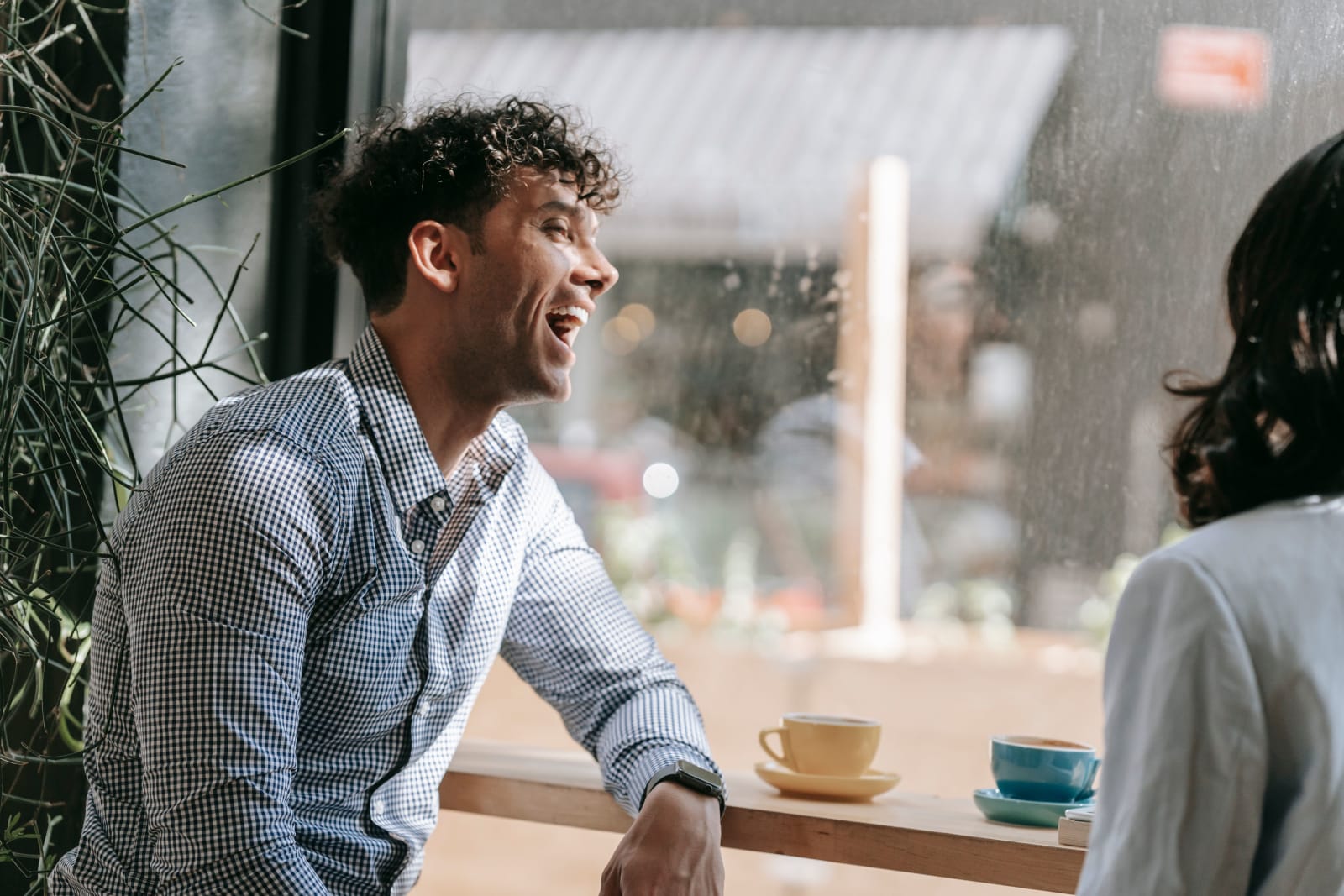 A man laughs at restaurant.